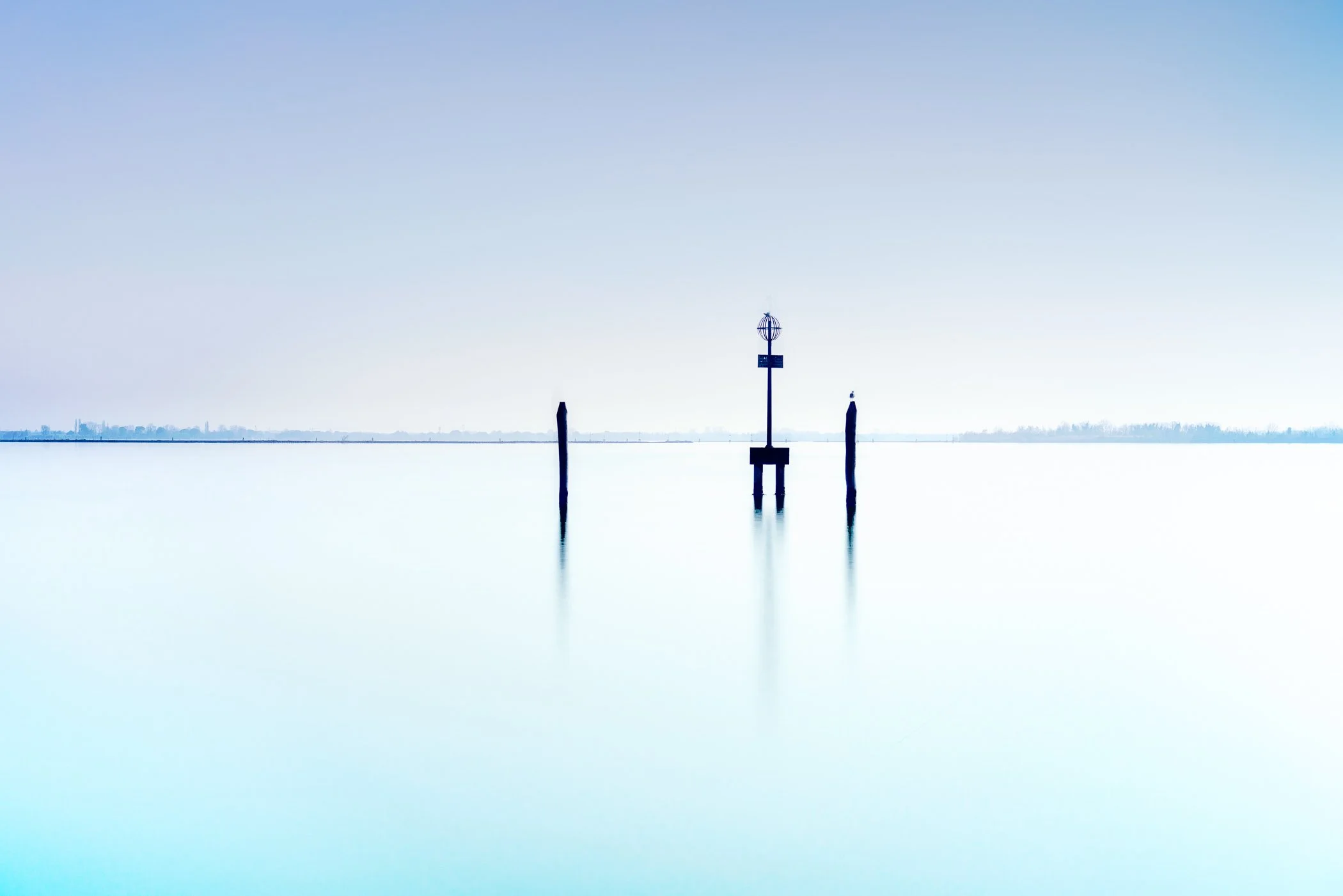Tranquil Morning An atmospheric early-morning landscape showcasing soft pastel skies and gentle light across the quiet lagoon.