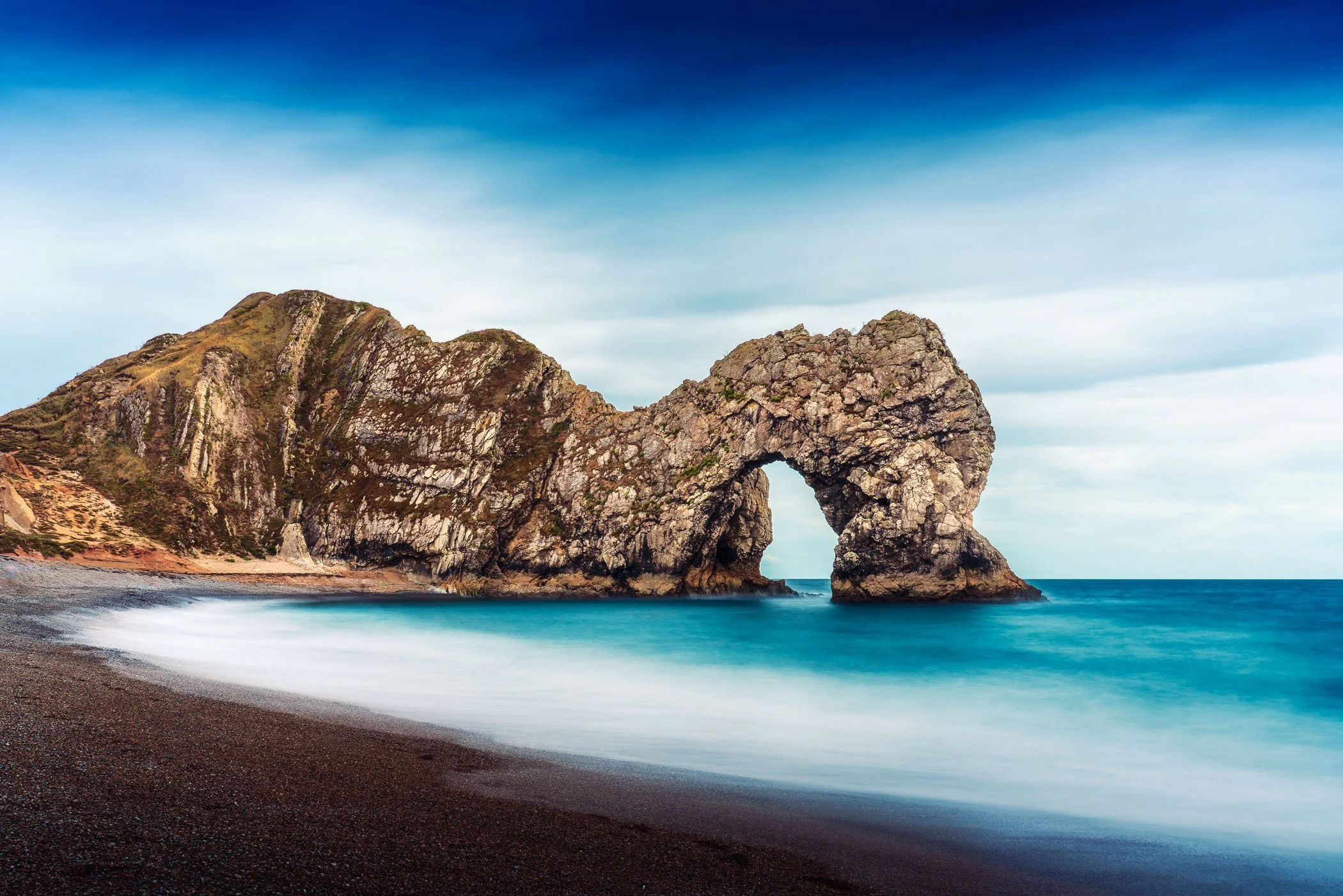 Durdle Door An iconic coastal photograph depicting the grand natural limestone arch carved by the sea along the Dorset coast.