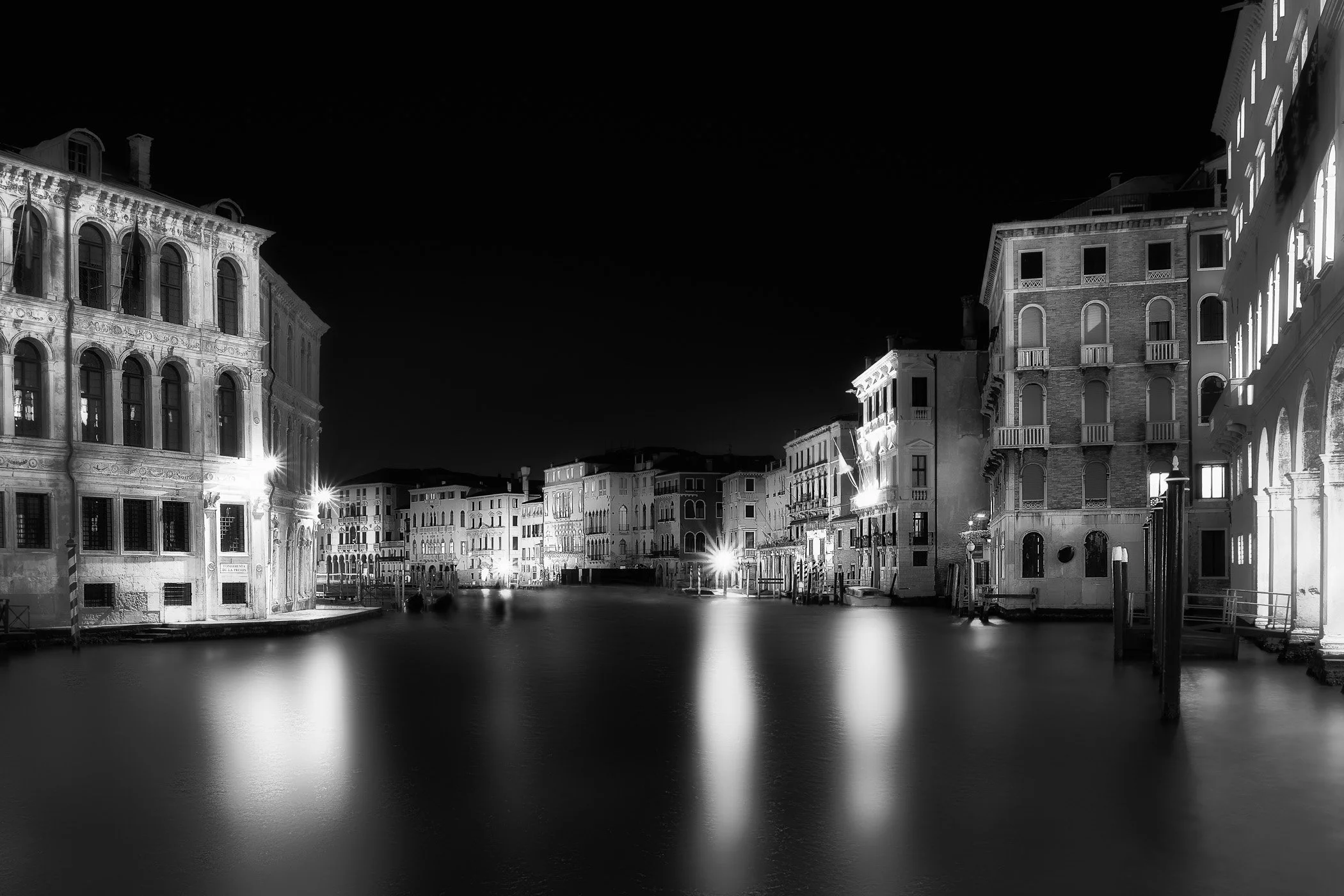Venice at Night Long-exposure night photography capturing tranquil waters and illuminated Venetian architecture.