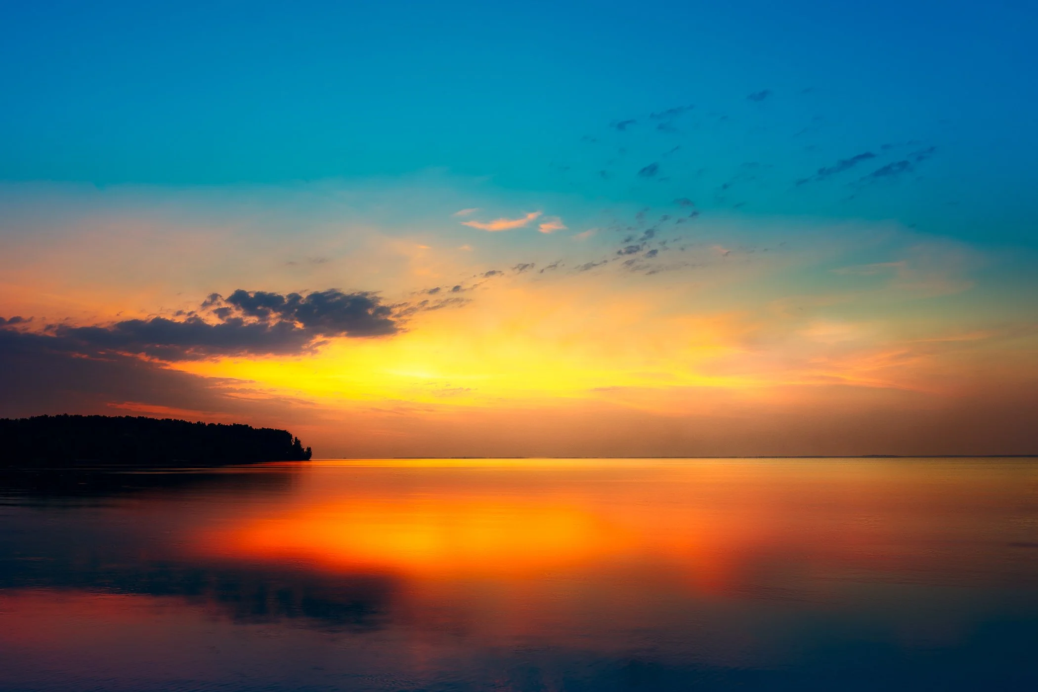 Serenity of a Sunrise Reflection A calm, balanced fine art photograph highlighting brilliant sky reflections dancing on the water's surface.