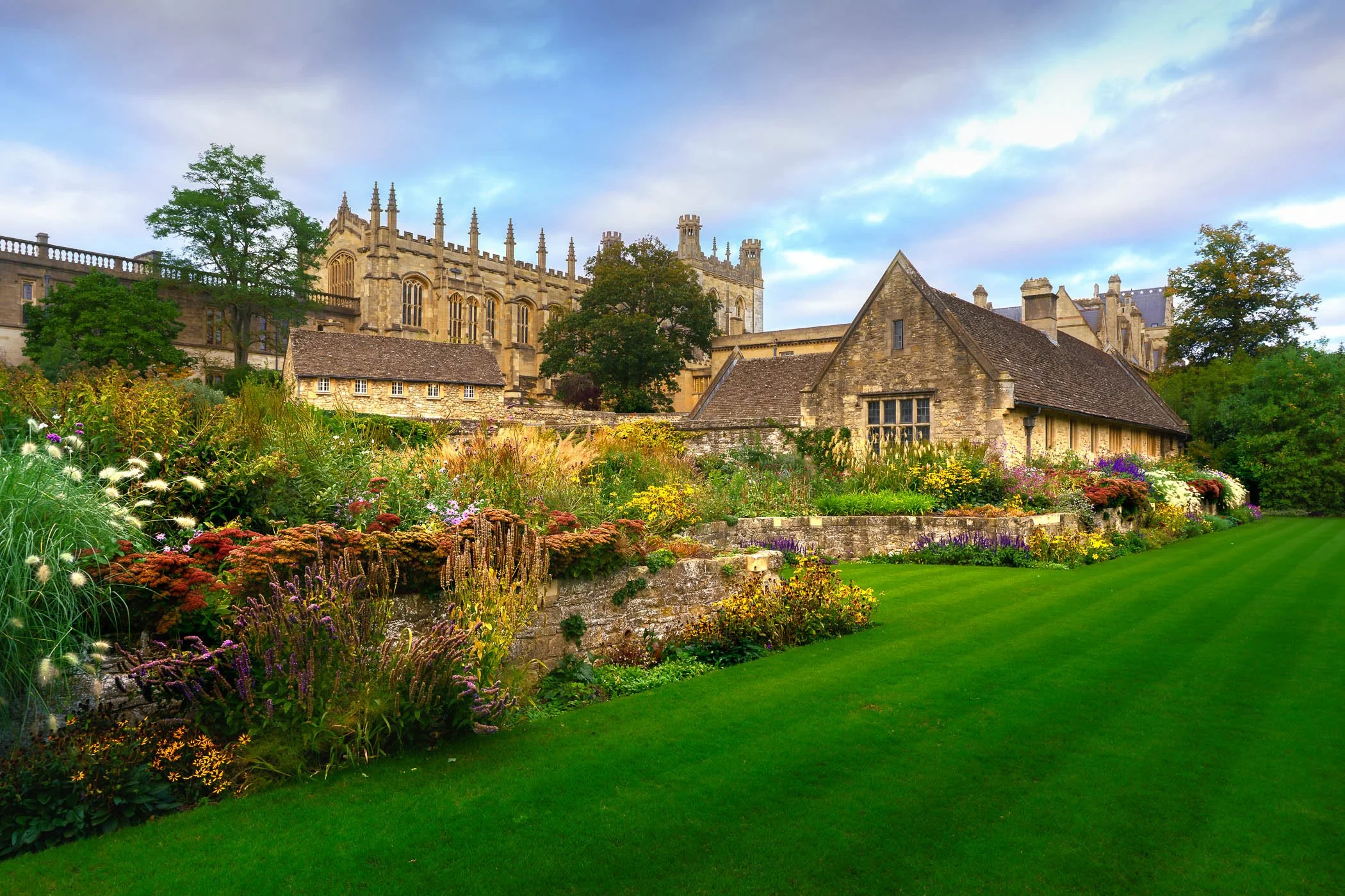 Flowerbeds before Christ Church, Oxford A vibrant shot featuring colourful floral displays in the foreground leading toward the historic Christchurch architecture.
