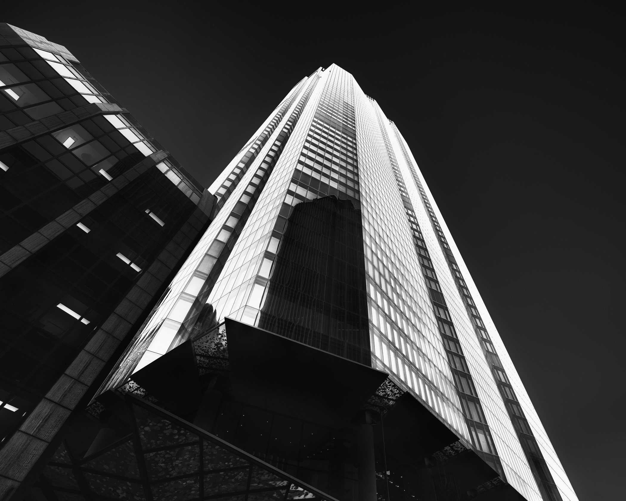 Bishopsgate Tower Dynamic architectural lines reaching upward into a high-contrast sky, highlighting contemporary glass and steel design.