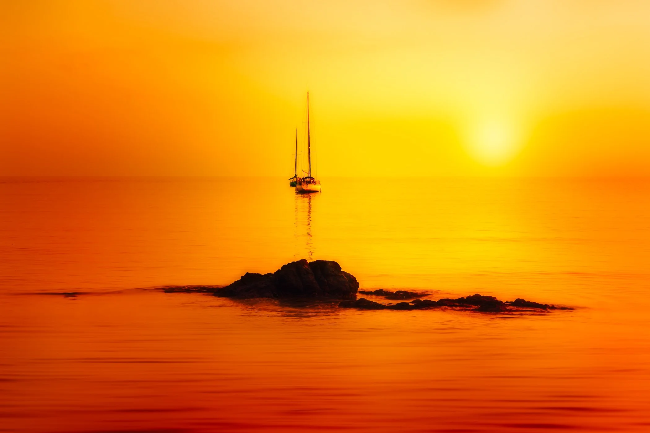 Golden Calm on the Open Sea A serene seascape showcasing tranquil, mirror-like waters reflecting golden sunlight along the Mediterranean coast.