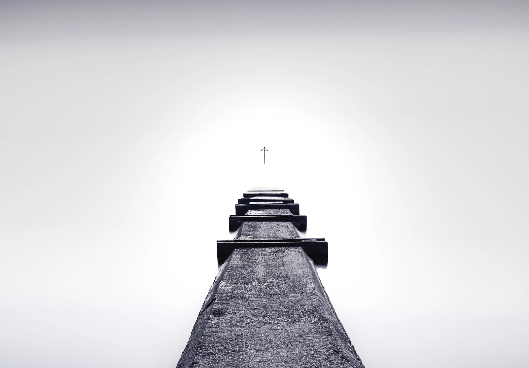 Path to Infinity A compelling perspective looking down a scenic coastal cliffpath leading towards the endless sea horizon.
