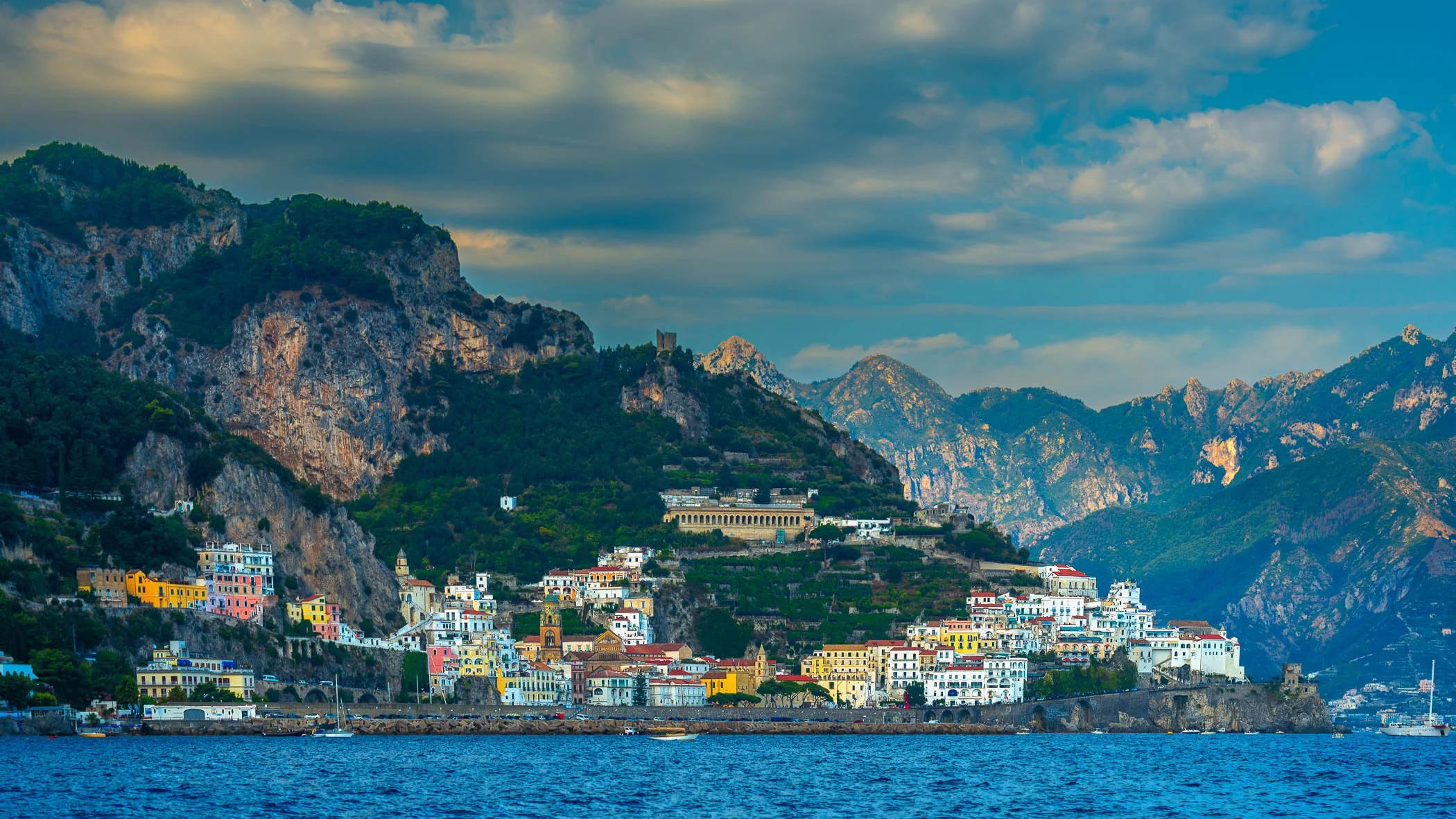 Amalfi from the Sea A scenic perspective taken from the water, showcasing the dramatic rise of Amalfi's colourful buildings tucked into the steep cliffs.
