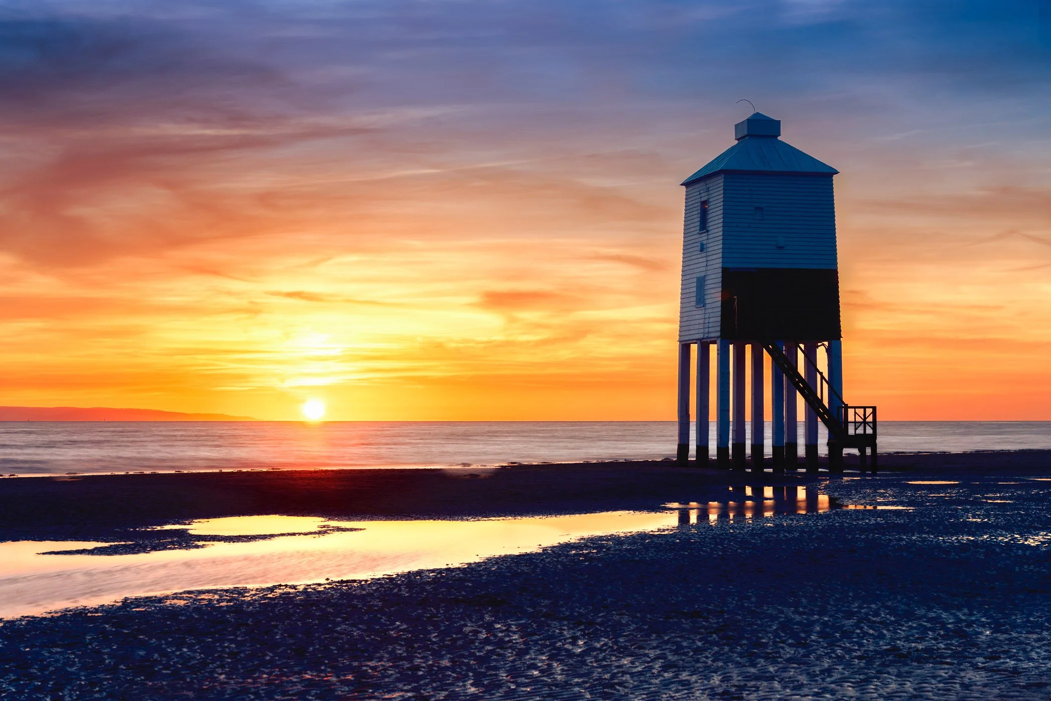 Burnham on Sea at Sunset A vibrant evening scene with deep golden light bathing the coast and horizon.