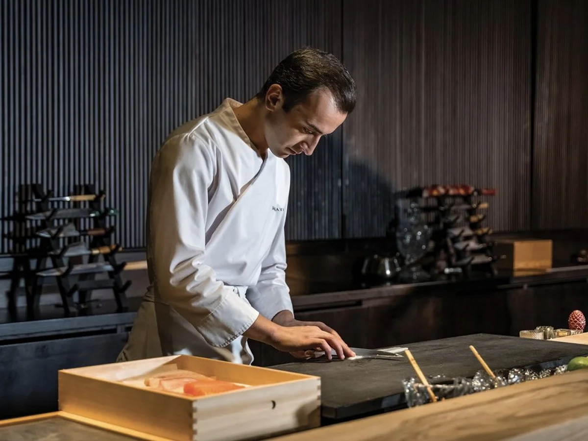 ushi chef preparing fresh nigiri during an omakase dining experience in Tokyo