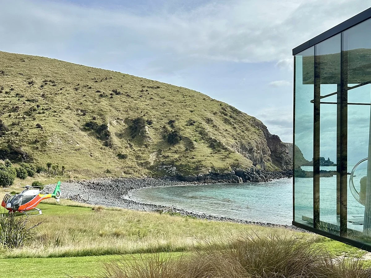 Helicopter arrival at Annandale luxury lodge on the remote Banks Peninsula coastline in New Zealand