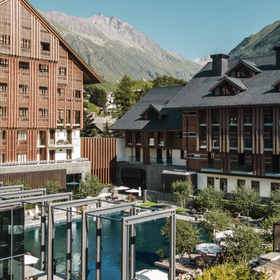 Luxury alpine resort The Chedi Andermatt with modern wooden architecture and mountain views