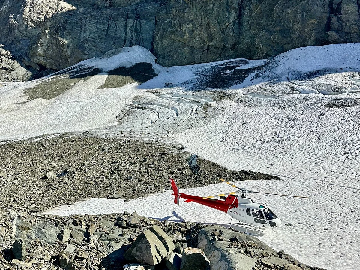 Helicopter landing on a glacier in the Southern Alps during a private New Zealand helicopter expedition