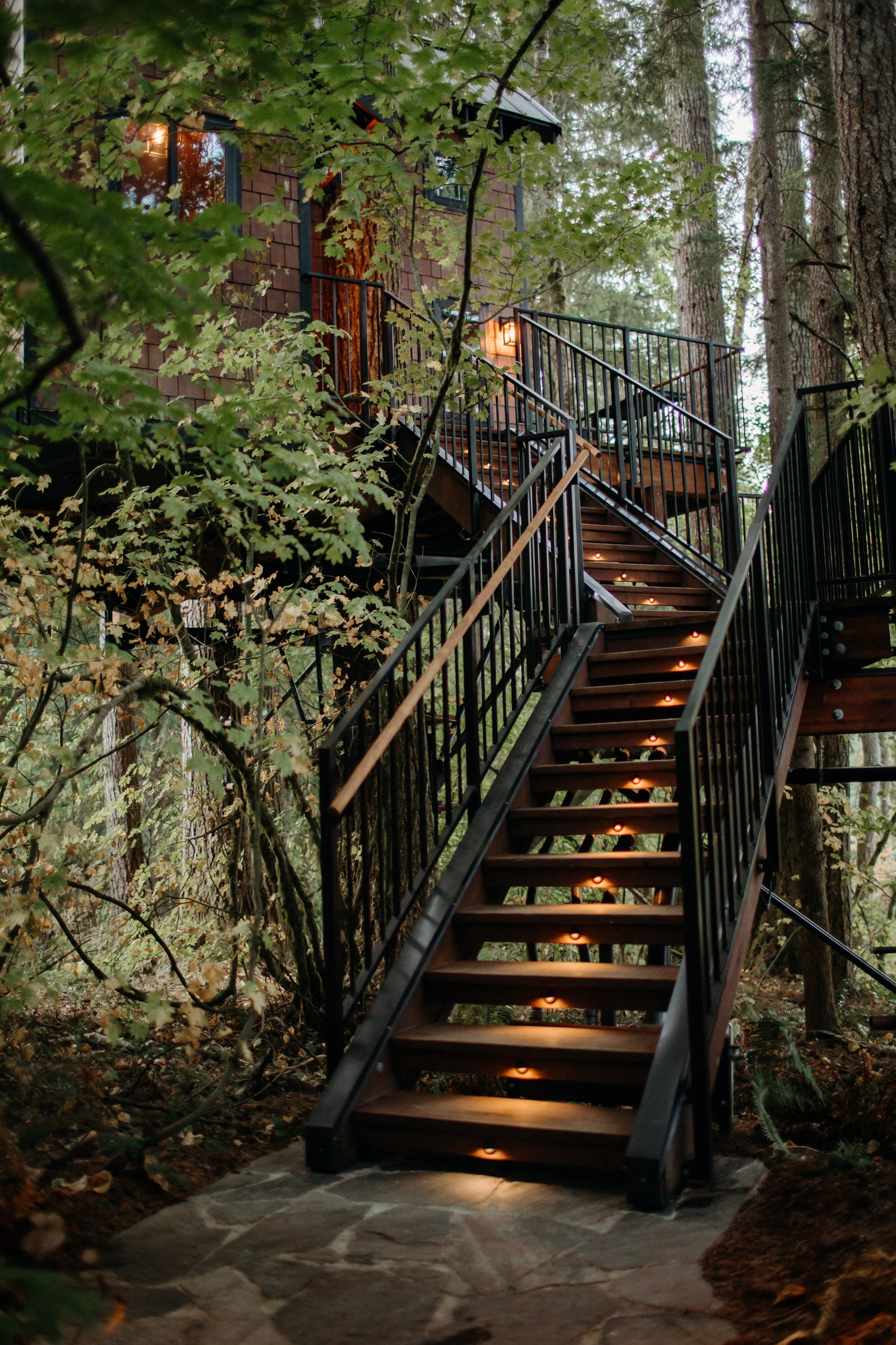 Custom treehouse stair access built in forest setting designed by treehouse architect Americana Architects.