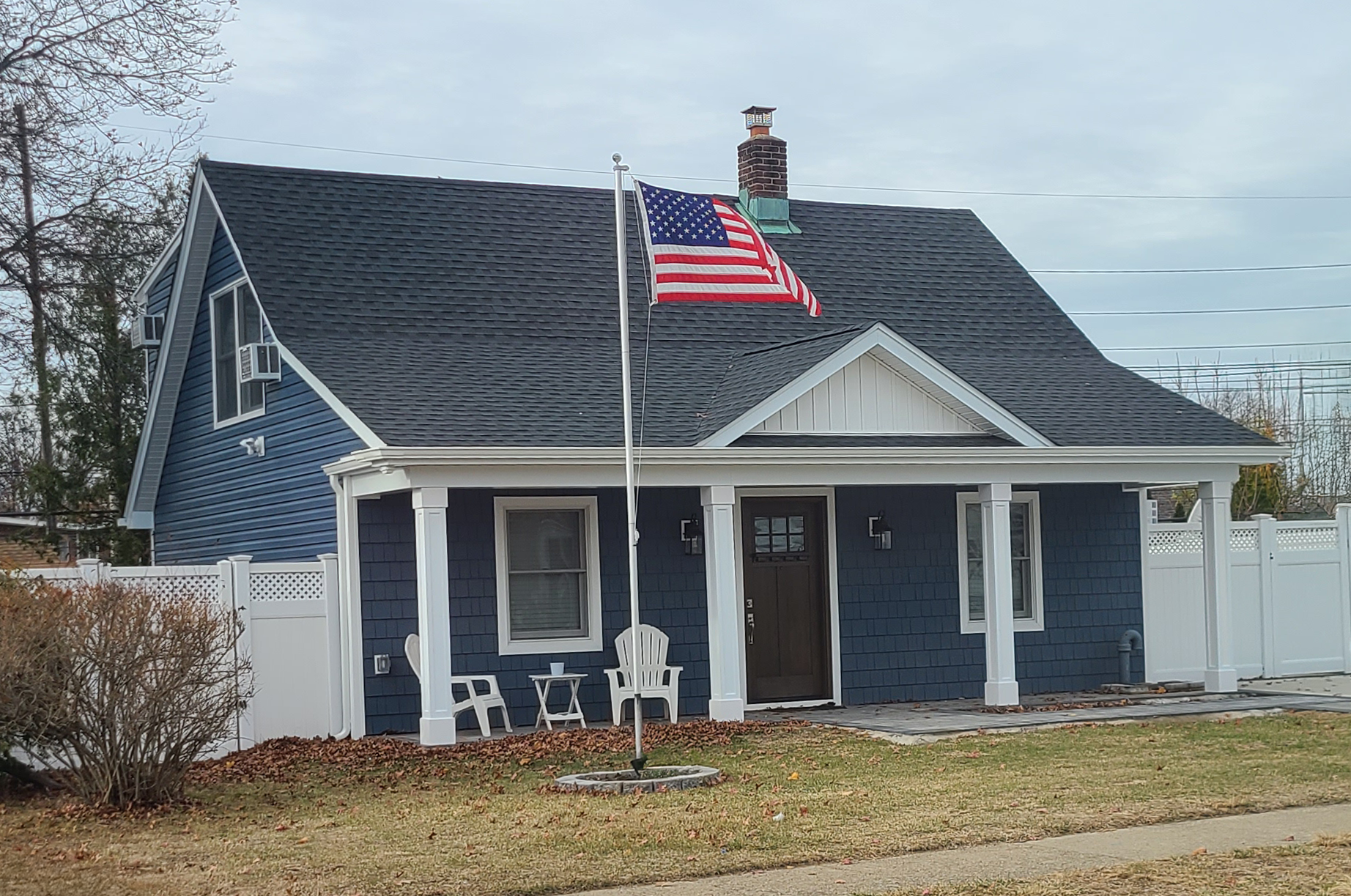 Completed Levittown renovation featuring new front porch and exterior upgrades designed by Americana Architects.