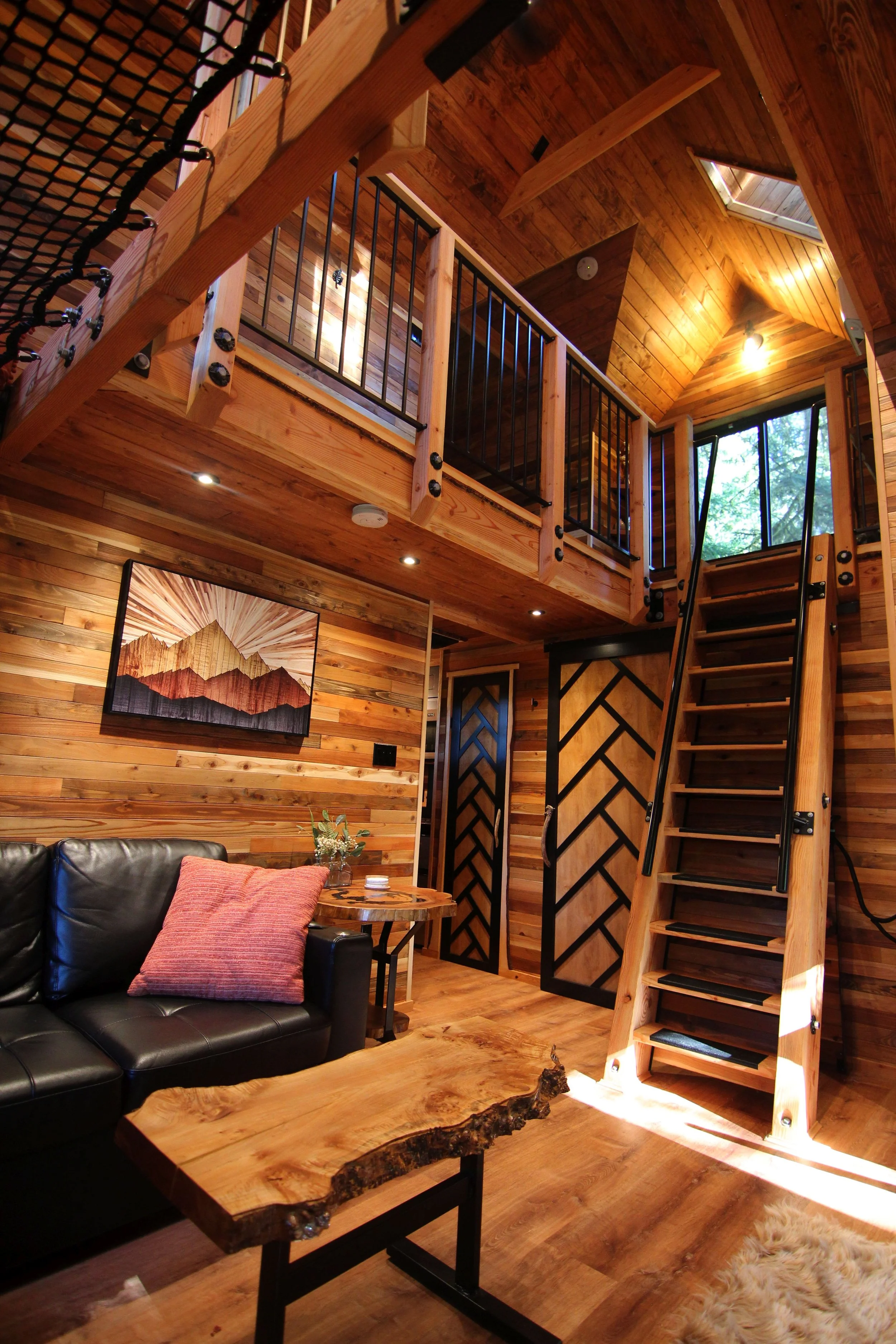 Luxury treehouse interior with loft and custom wood detailing designed by treehouse architect Americana Architects.