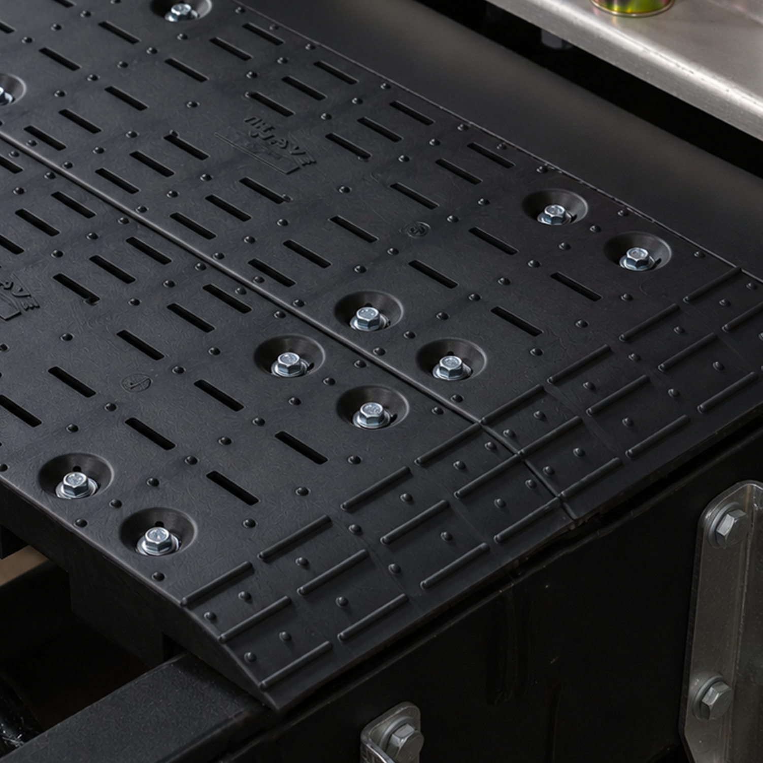 Close up image of the edge of The Wave Deck, focusing on the grips and texture