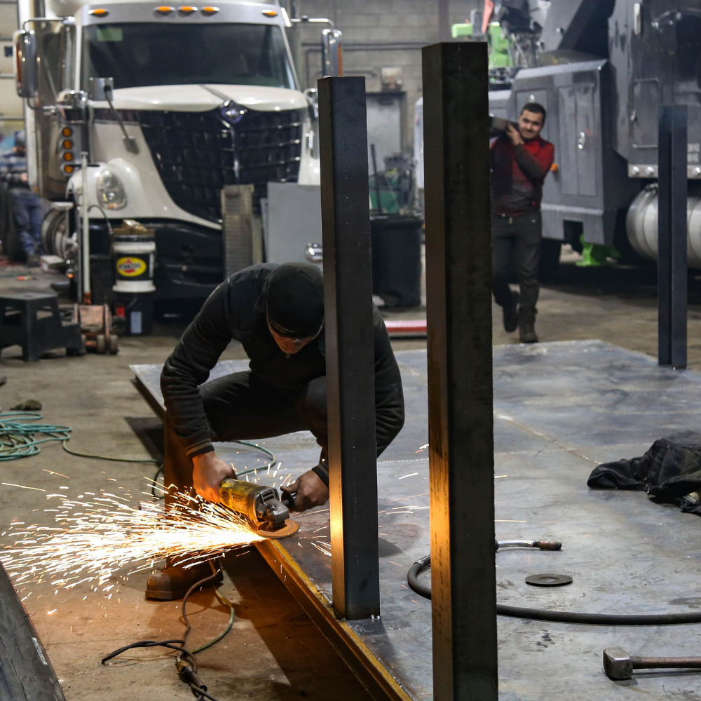 Image of a mechanic welding a metal deck
