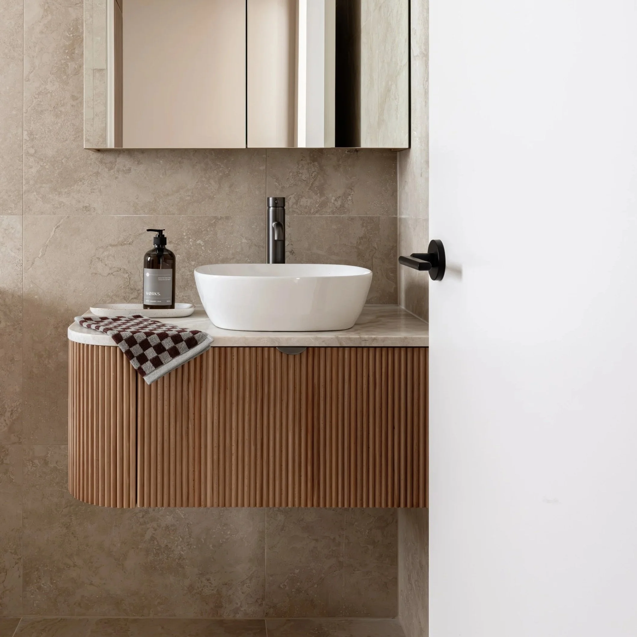 warm timber vanity and stone bathroom