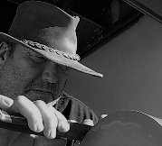 Paul Cody sharpening a knife on a whetstone