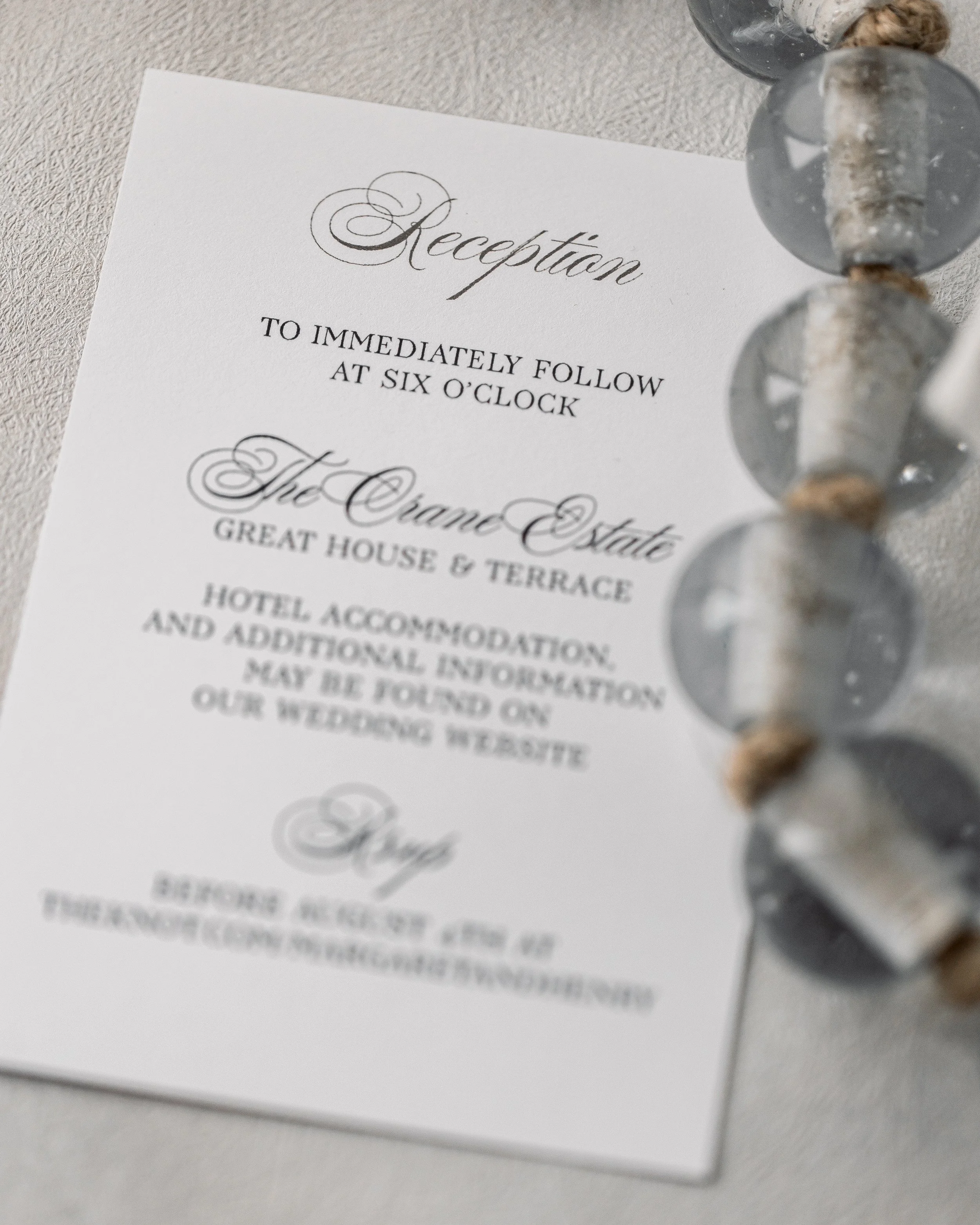 Reception insert continues the matte, digital, and ribbon details, harmonizing with the main suite.