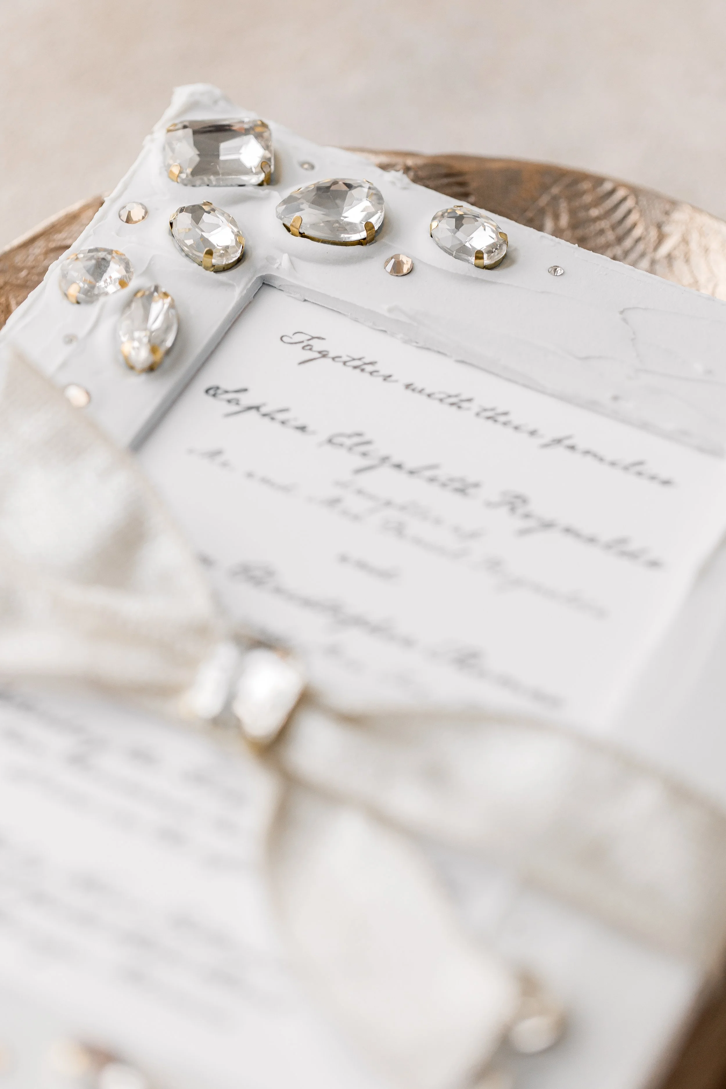 Crisp black digital printing rests beneath the signature matte overlay, balancing the ornate embellishments with modern clarity.