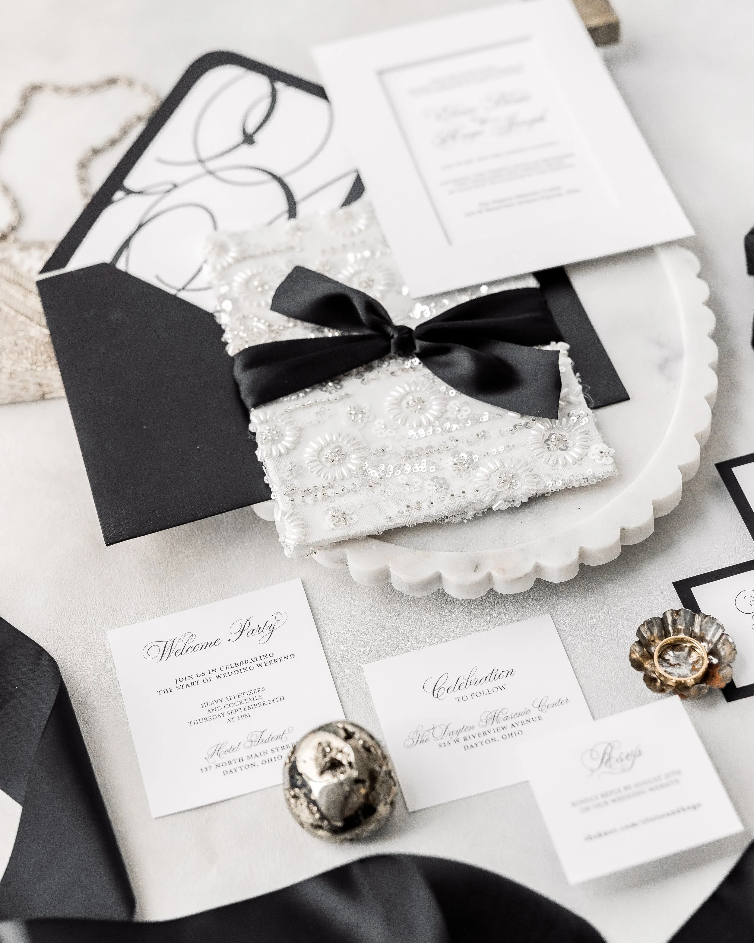 The invitation’s structural elegance, paired with the dimensional embellishments, encourages a slow, tactile interaction, inviting guests to linger over each detail.