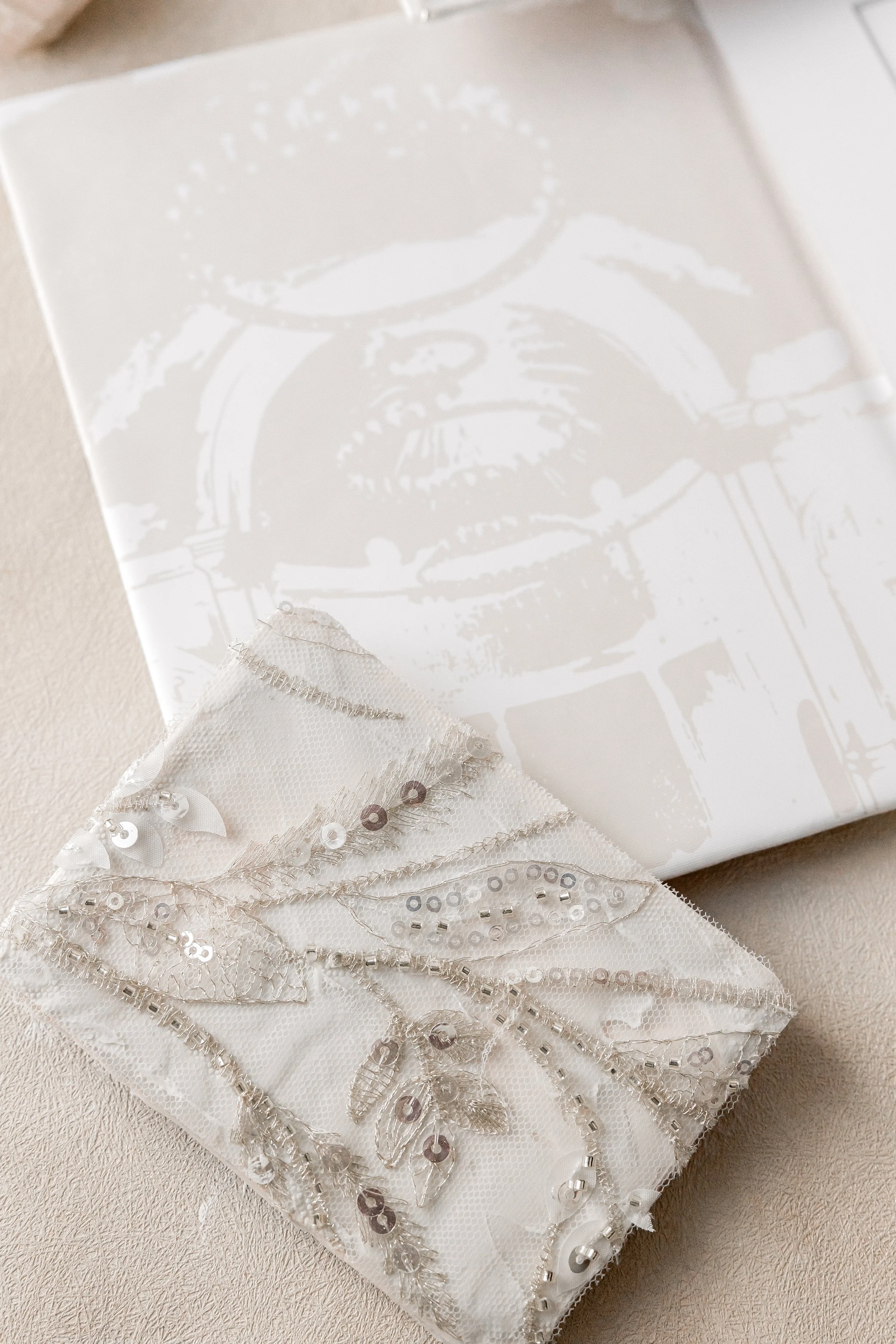 A custom watercolor of the venue lines the envelope, printed in soft, muted tones on vinyl for a smooth, unexpected textural reveal as the invitation is opened.