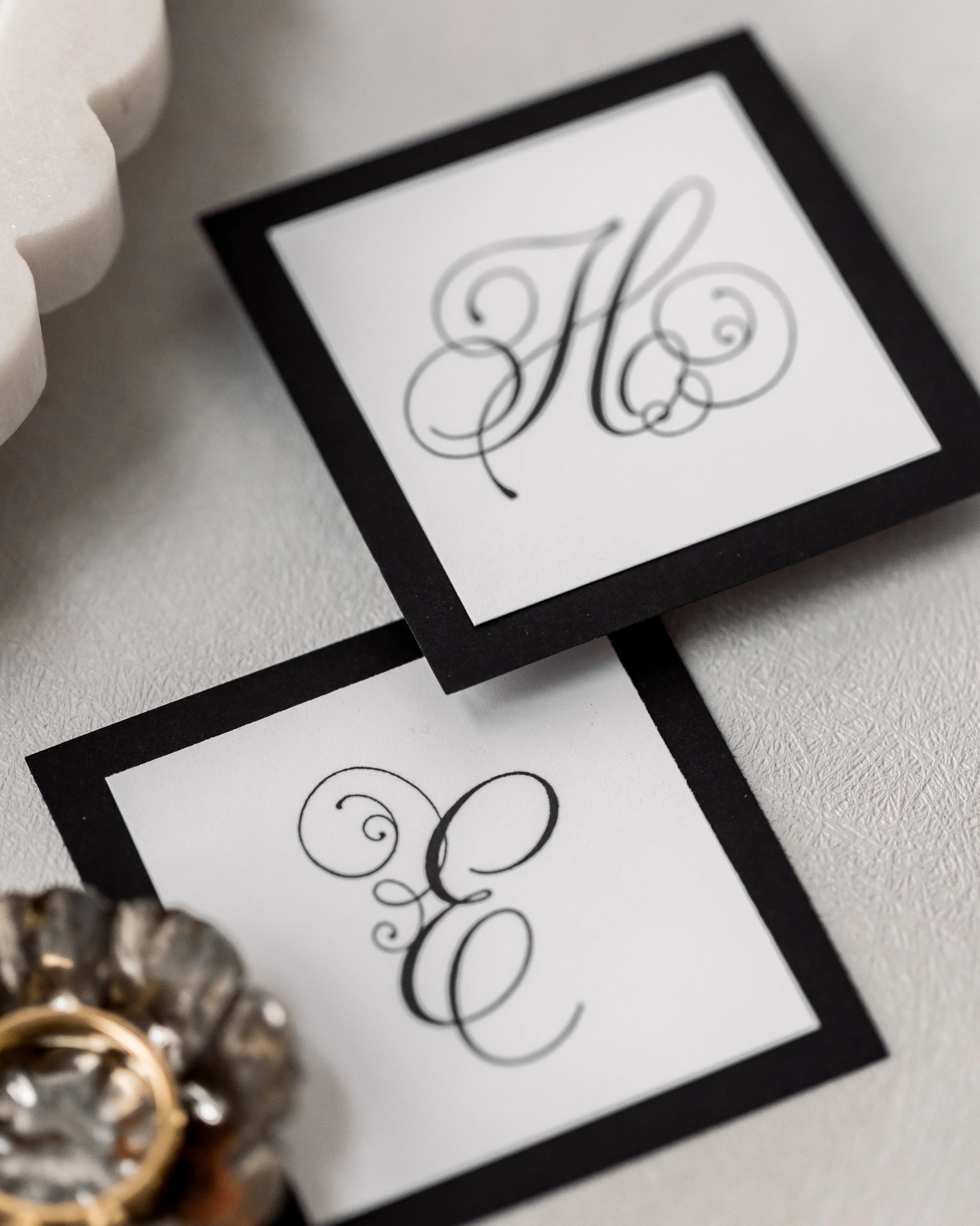 The combination of black matte stock, digital printing, and textural embellishments ensures each element feels like part of a cohesive, artful whole.