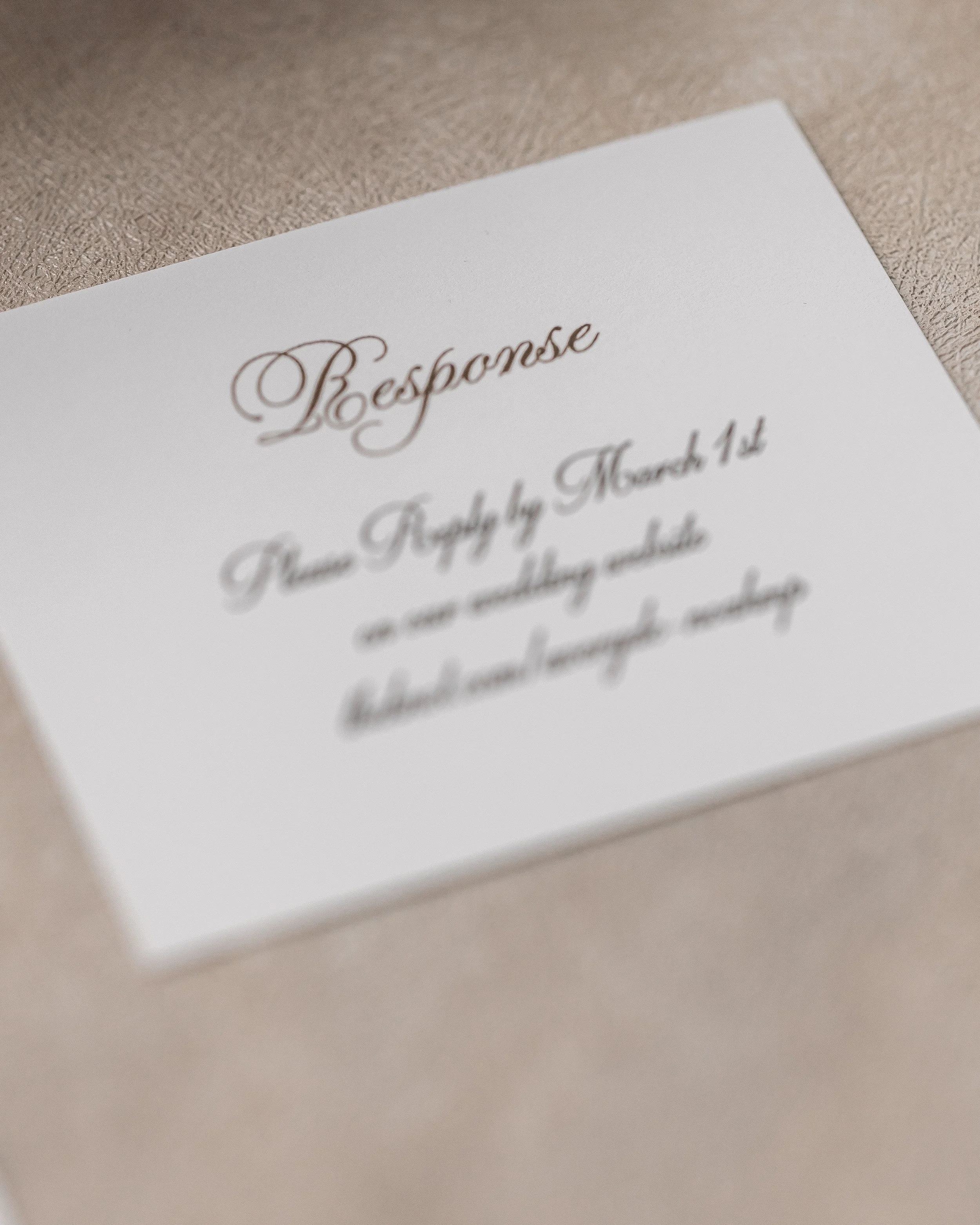 Designed on heavy cardstock with black digital printing, the response card maintains the matte-style structure while remaining cohesive with the suite’s color palette and metallic accents.