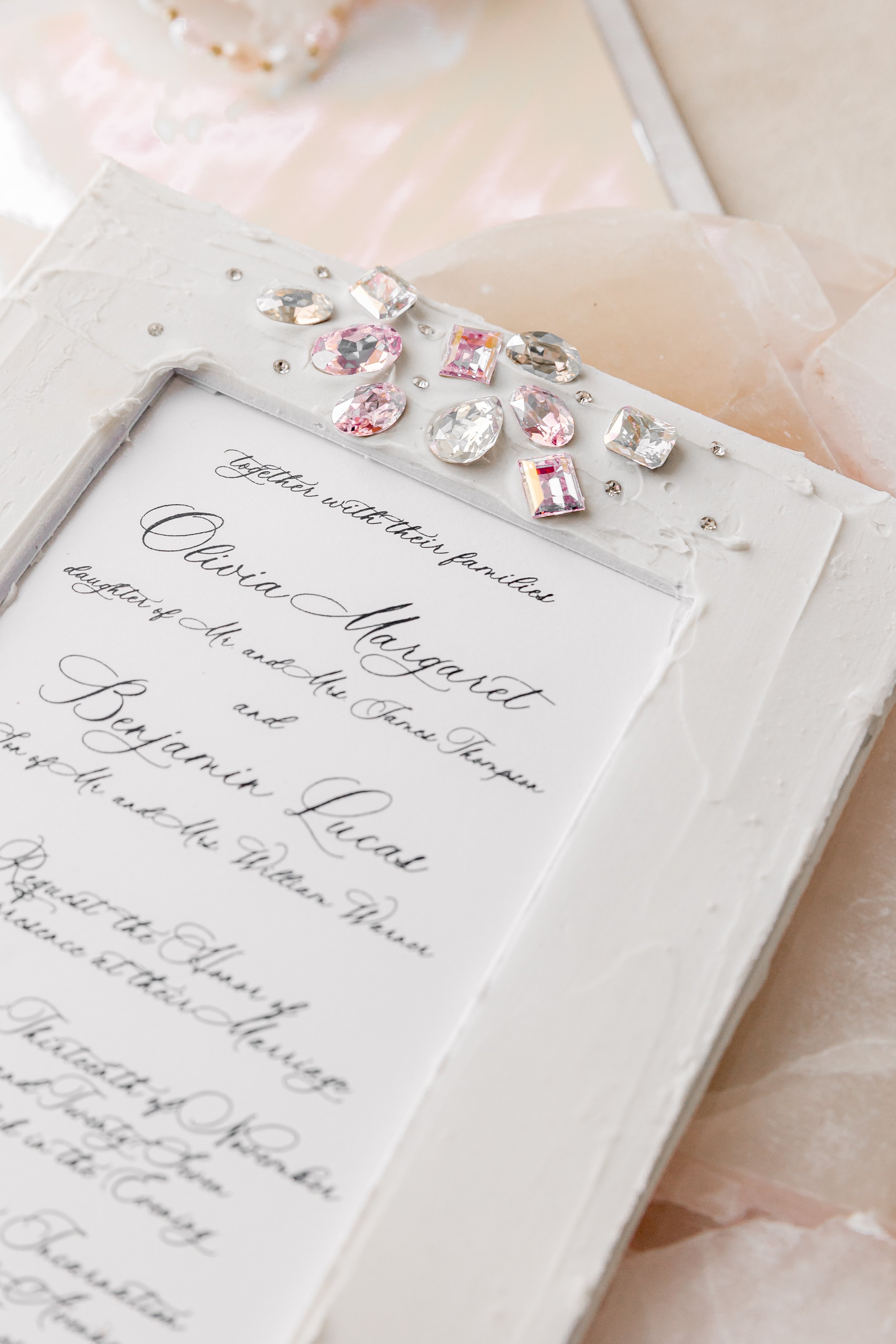 The signature matte overlay adds depth and structure, framing the printed design while softening the glow of the rhinestones beneath.