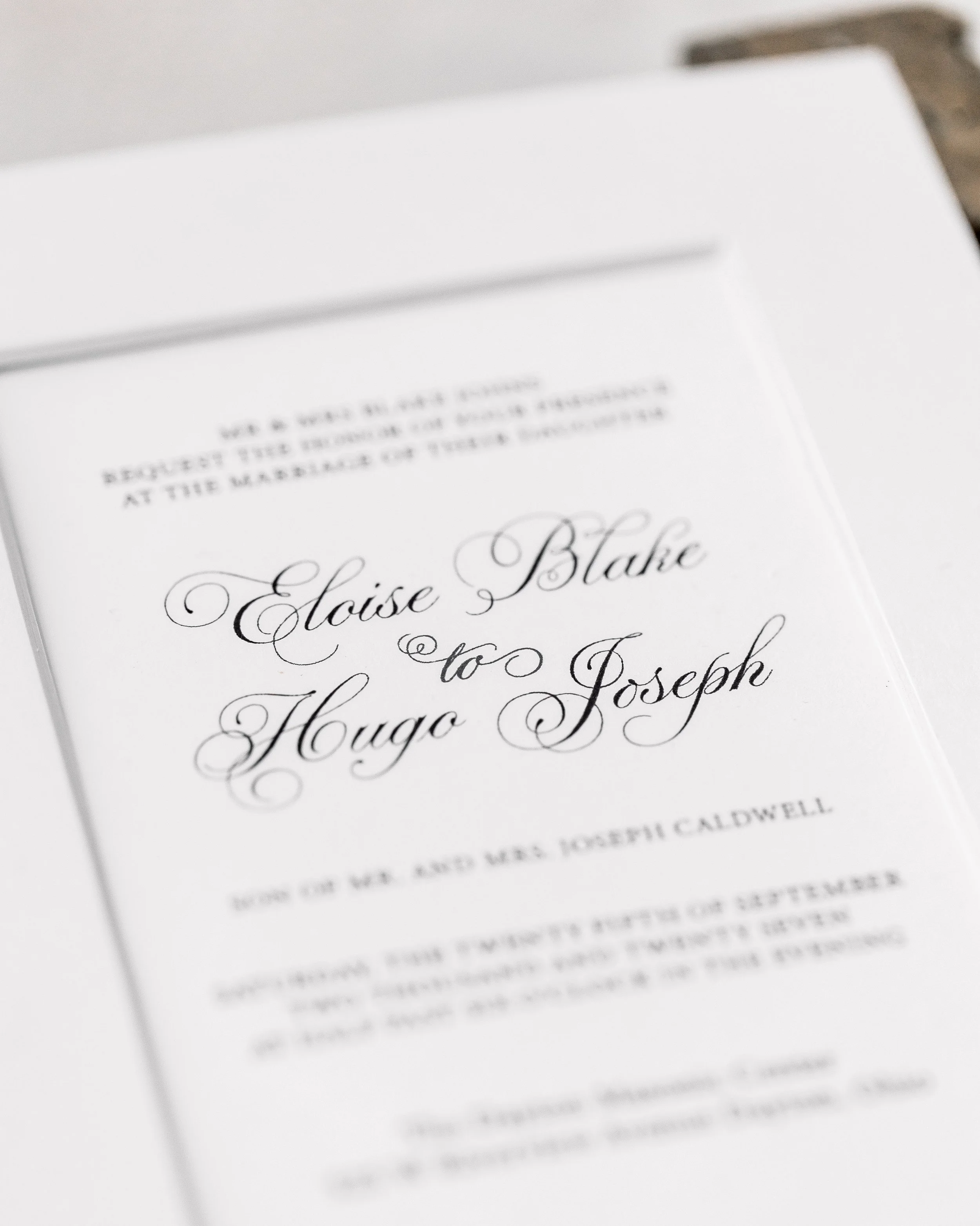 Black digital printing beneath a white matte overlay anchors the design, offering contrast and clarity that balances the suite’s luminous embellishments.