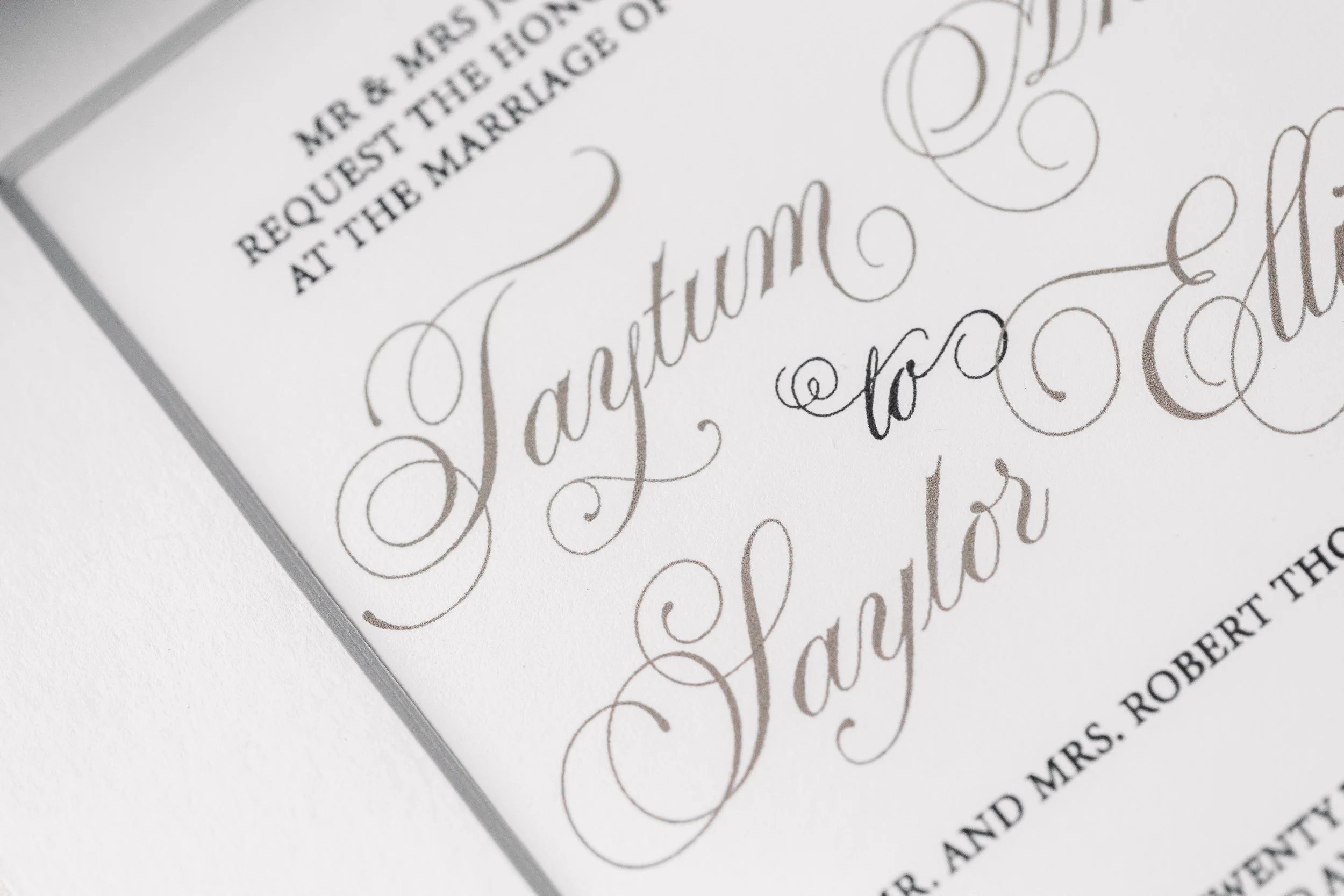 The invitation rests beneath a tailored matte, adding dimension and subtle framing that enhances the clean lines of the printed design.