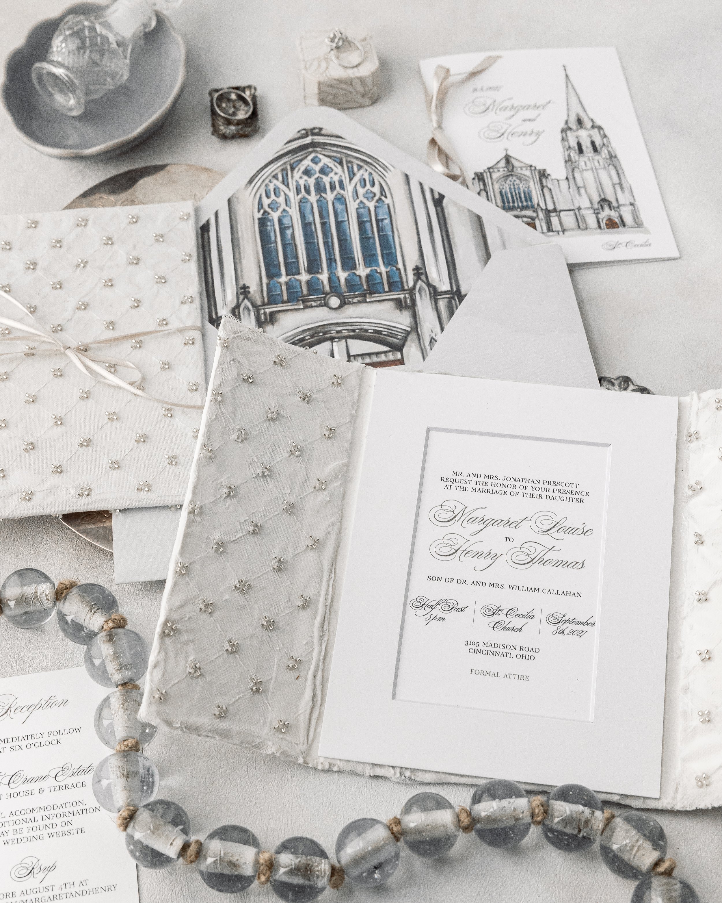 Dimensional textures, watercolor accents, and ribbon combine to make the suite tactile, luminous, and cohesive.