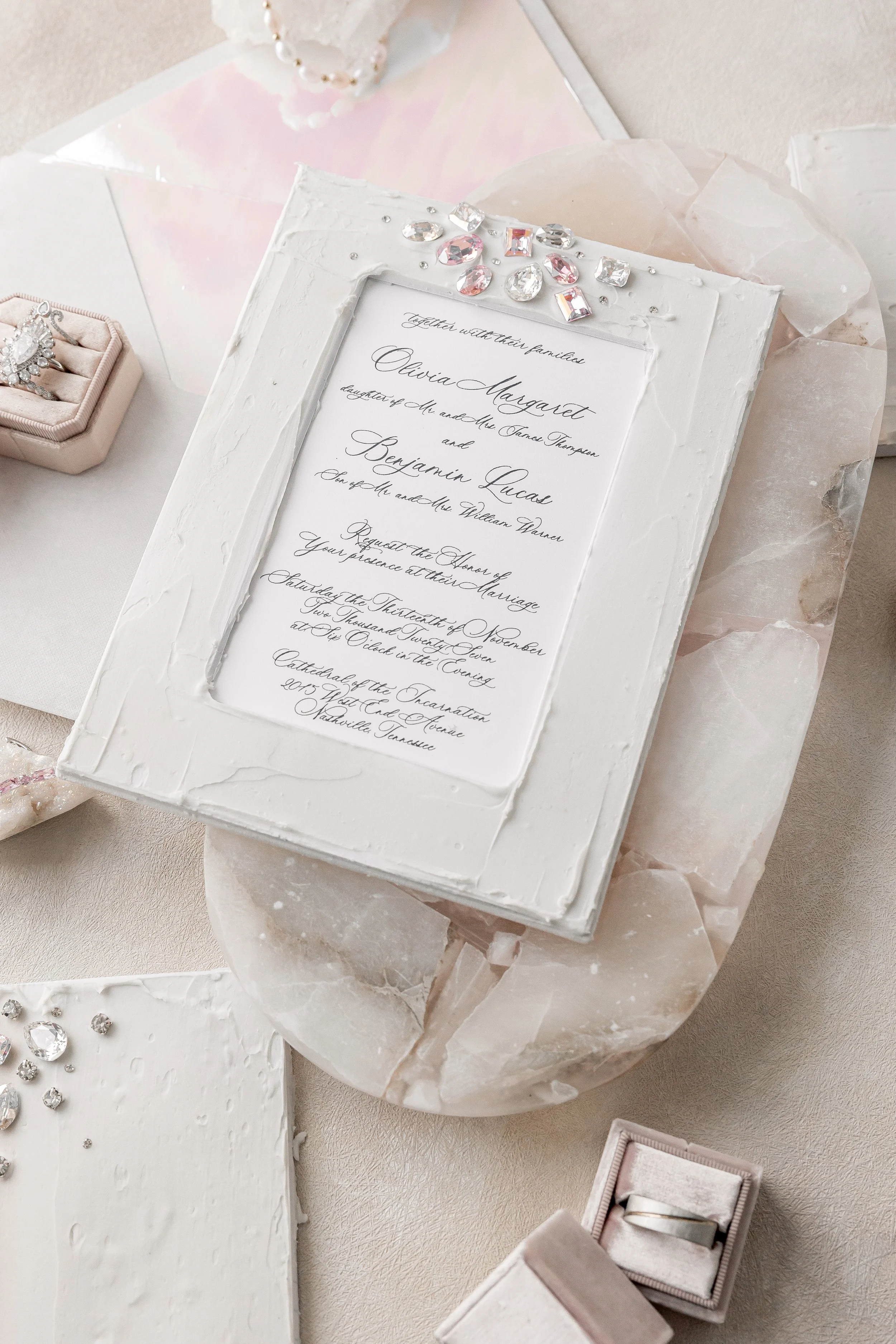 From this perspective, the combination of matte layers, rhinestones, and coordinated vow books is revealed as a cohesive, textural, and light-reflecting suite.
