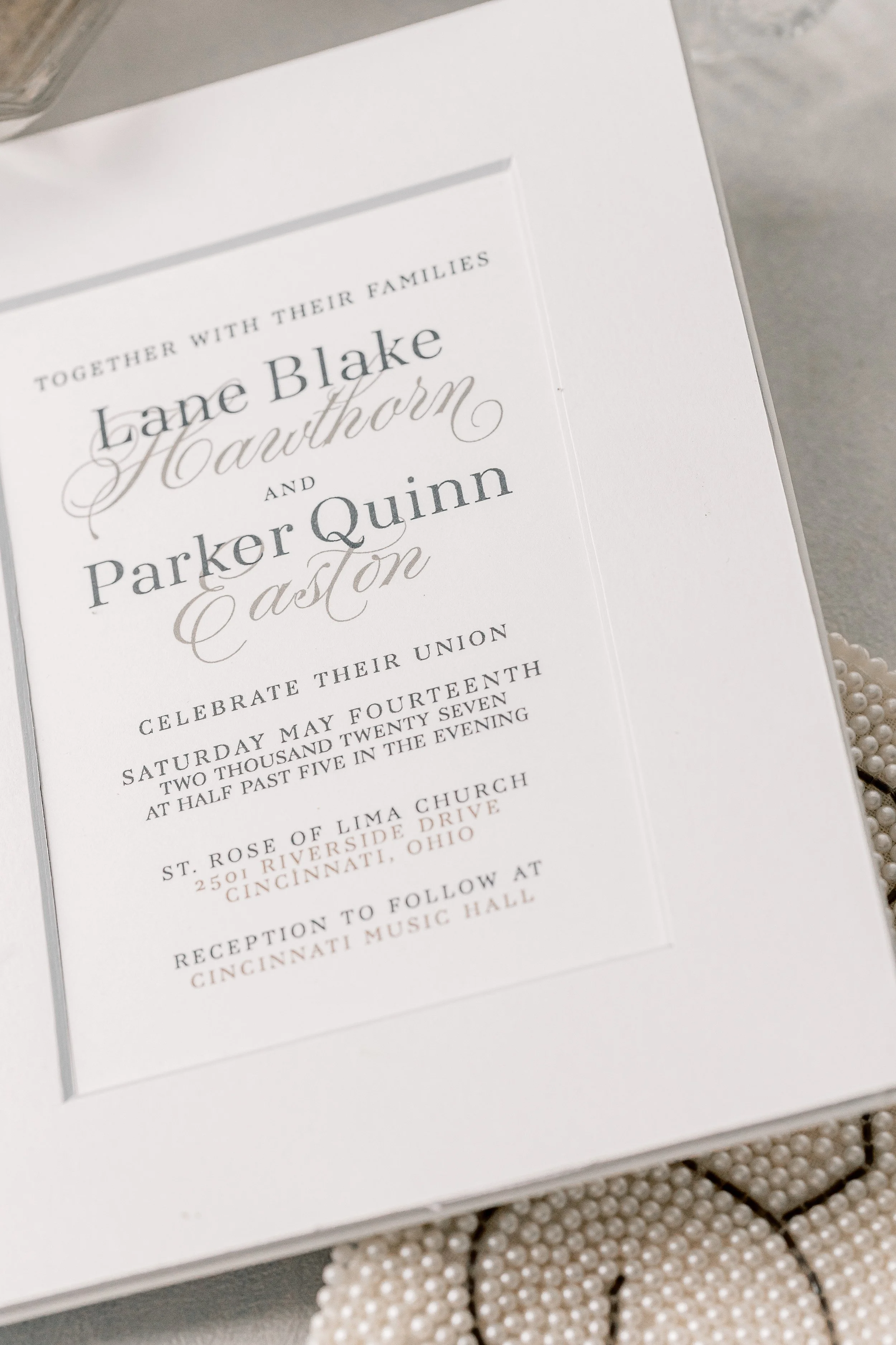 The invitation was mounted under a beveled edge mat board and then mounted to the inside of NOTE's signature book-style invitation suite.