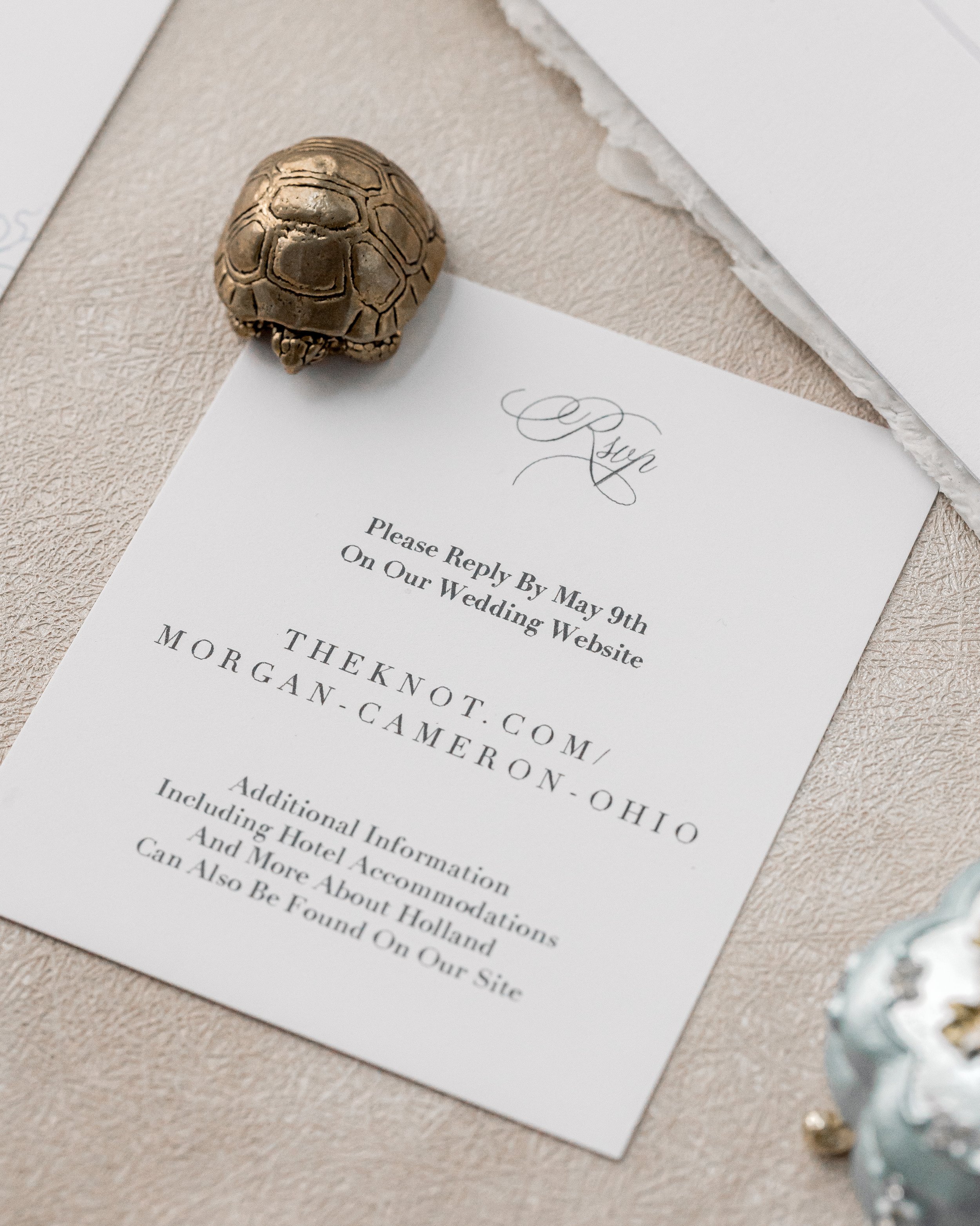 Enclosed RSVP card maintains the gatefold’s matte and fabric detailing, echoing the suite’s typography and texture on a smaller, more functional format.