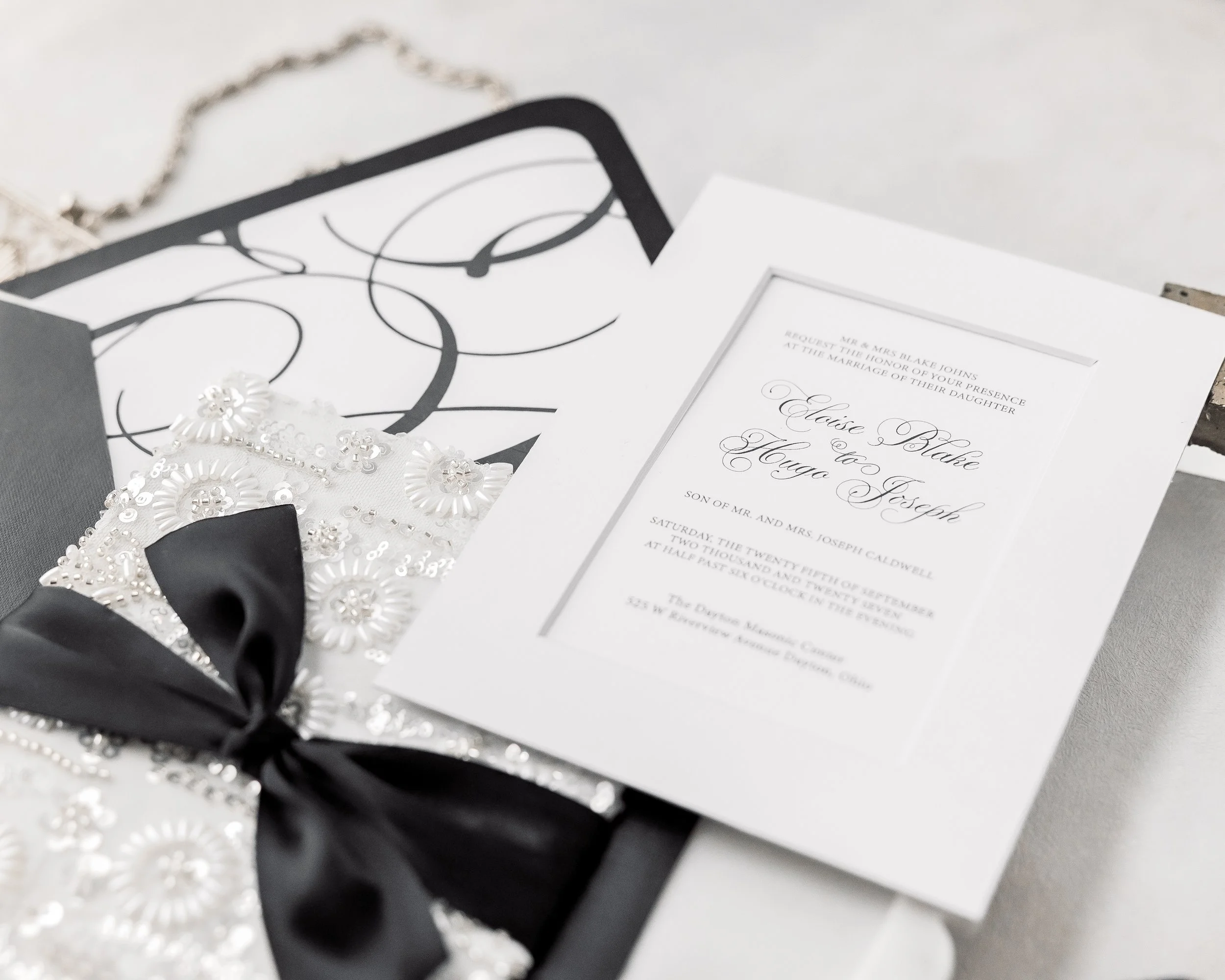 The monogramed envelope liner, printed on vinyl, carries the suite’s identity, echoing the subtle sophistication of the invitation itself.