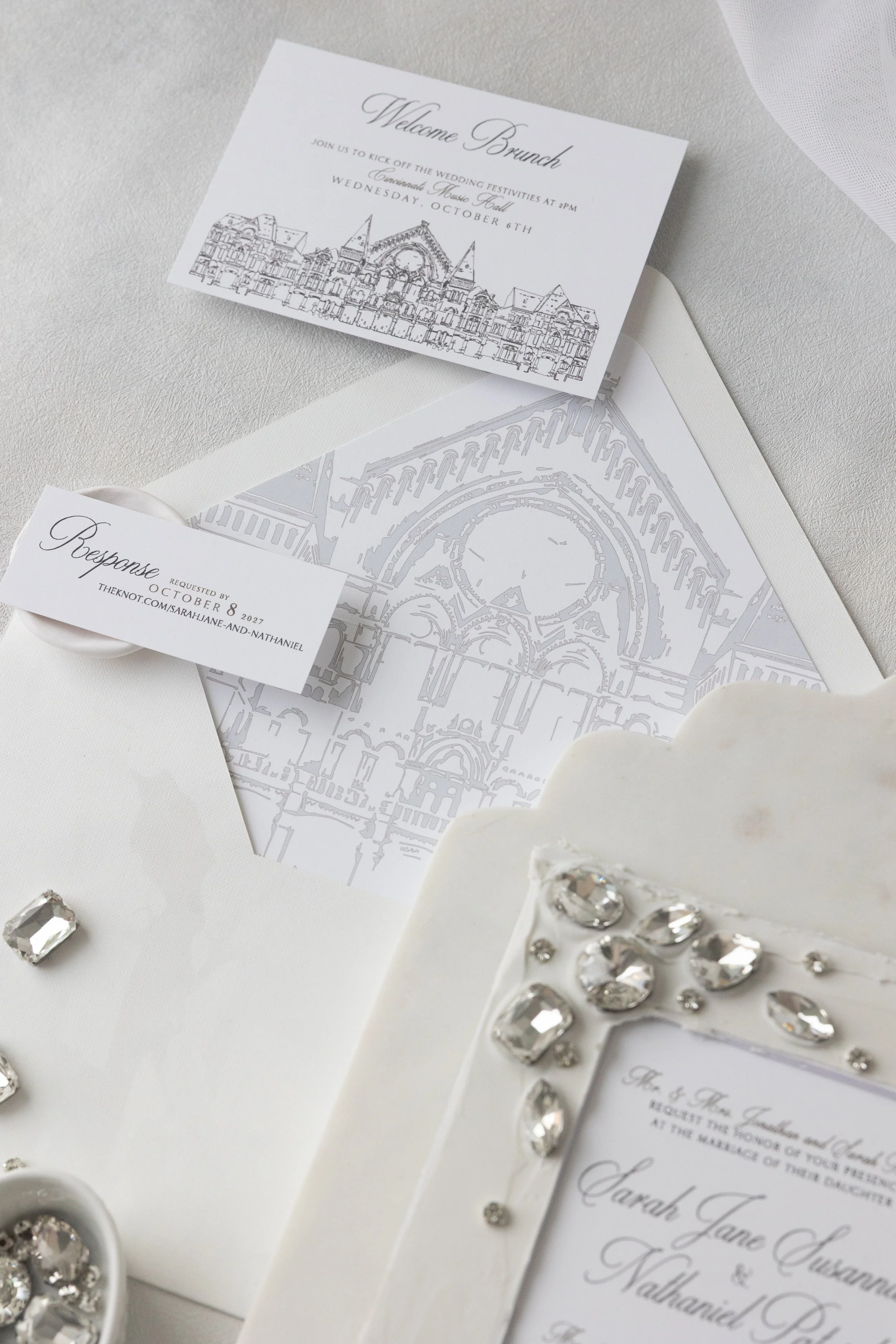The envelope liner features a custom illustration of Music Hall printed in soft grey digital ink on vinyl, offering an unexpected textural reveal the moment the envelope is opened.