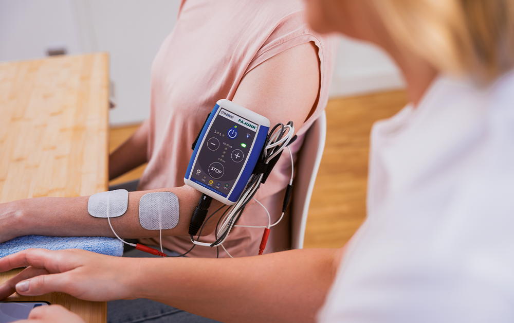 A healthcare professional checking a patient's blood pressure using a digital monitor at a healthcare facility.