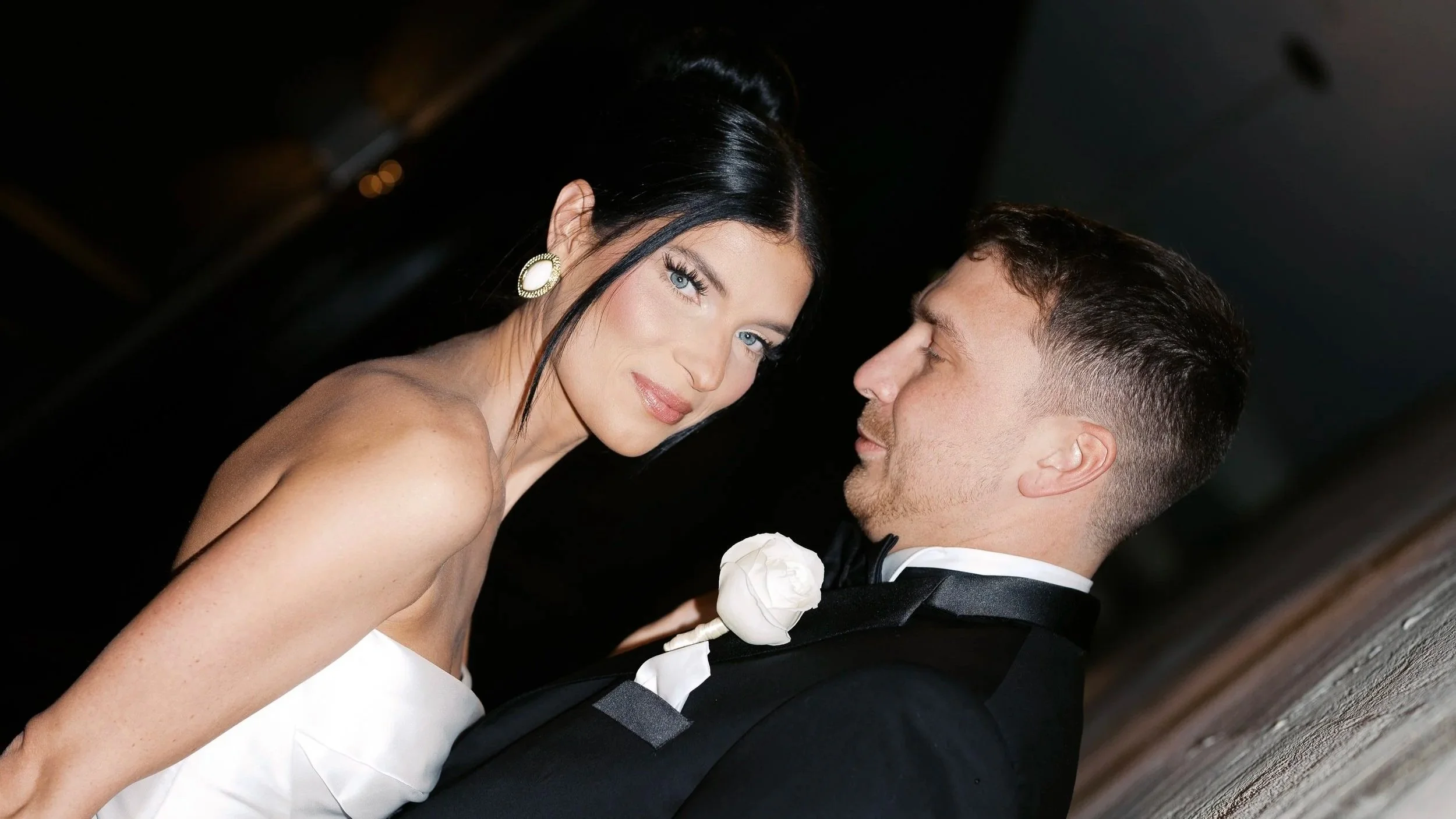 A woman and man dressed in formal attire, close together at an event or celebration.