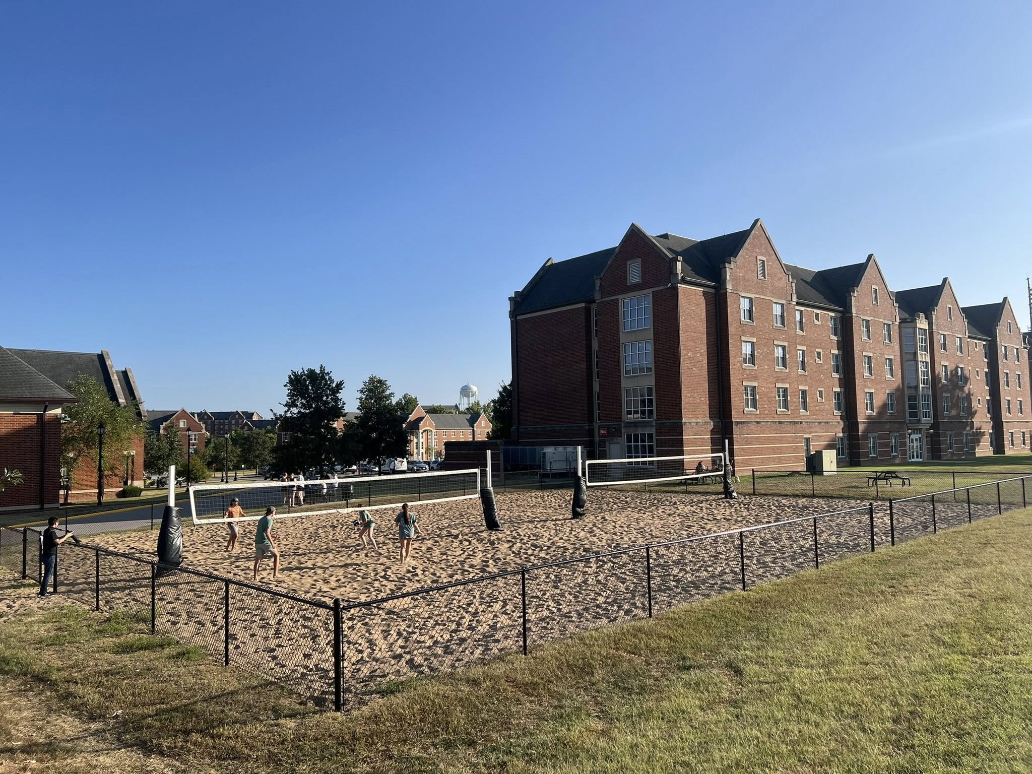black chain link fence around a sand volleyball court - Midwest Fence