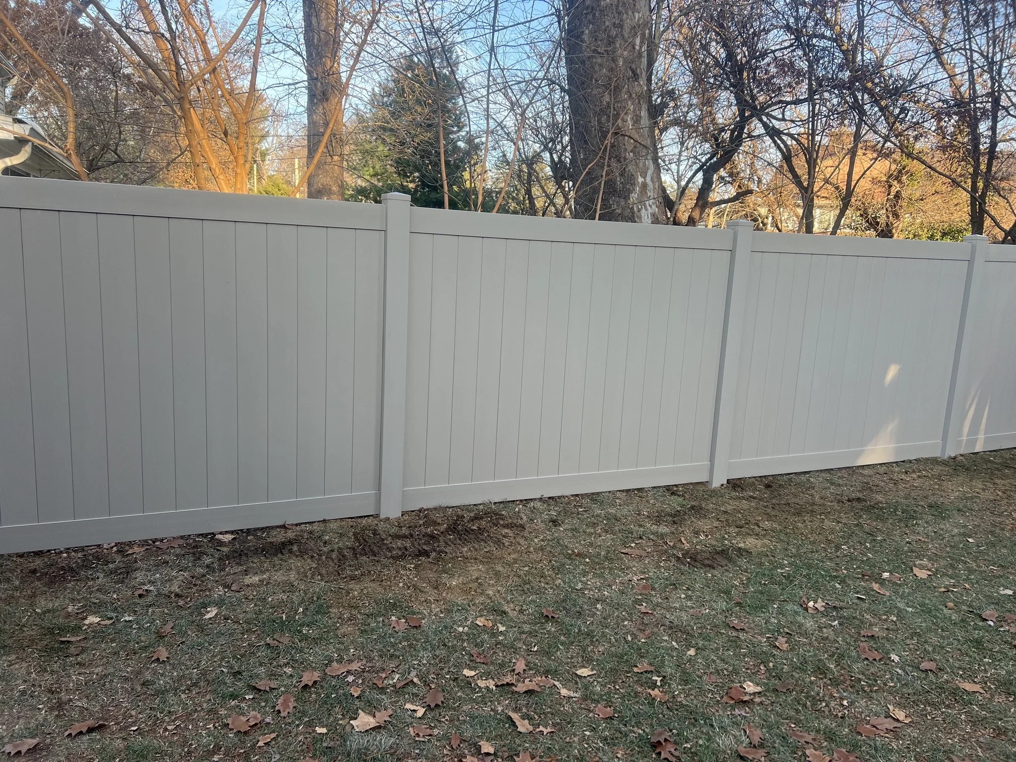 Tan vinyl privacy fence installed in St. Charles, Missouri