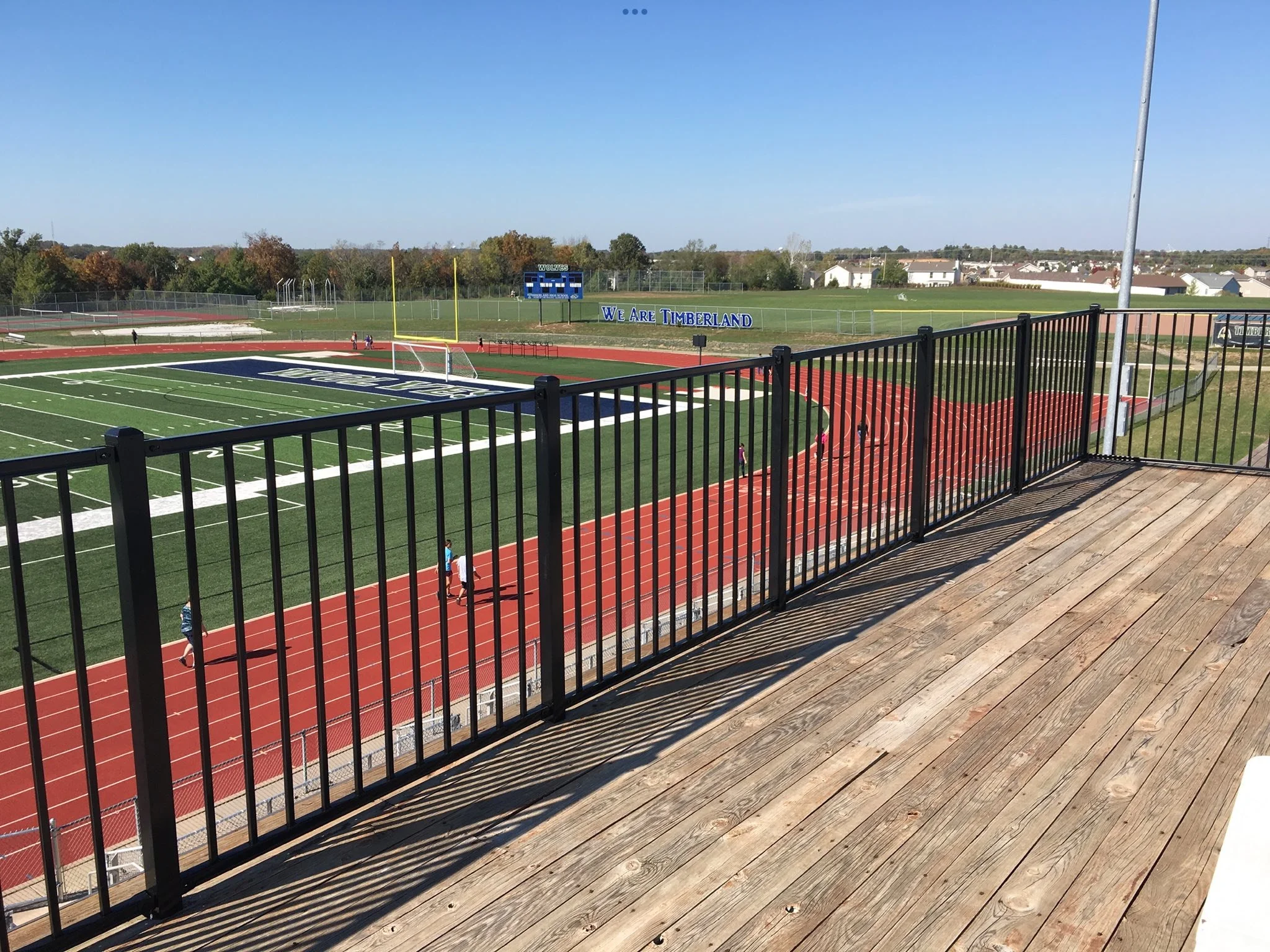 black ornamental aluminum fence above a football field stadium - Midwest Fence