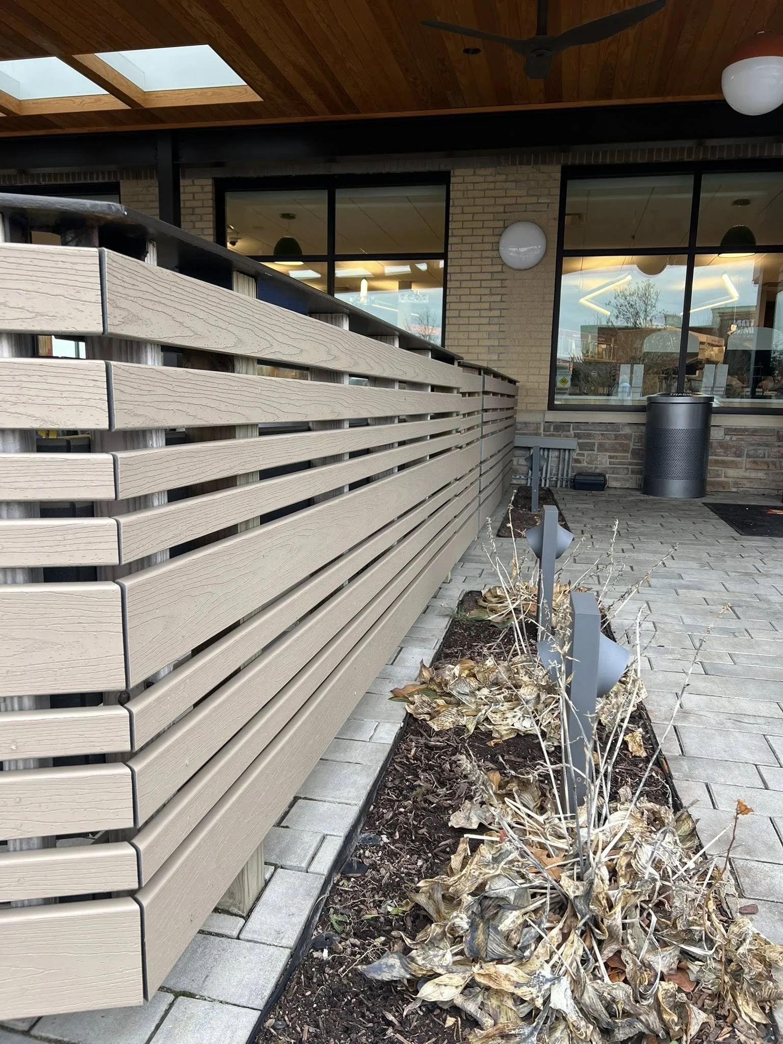 light brown horizontal composite around restaurant patio - Midwest Fence