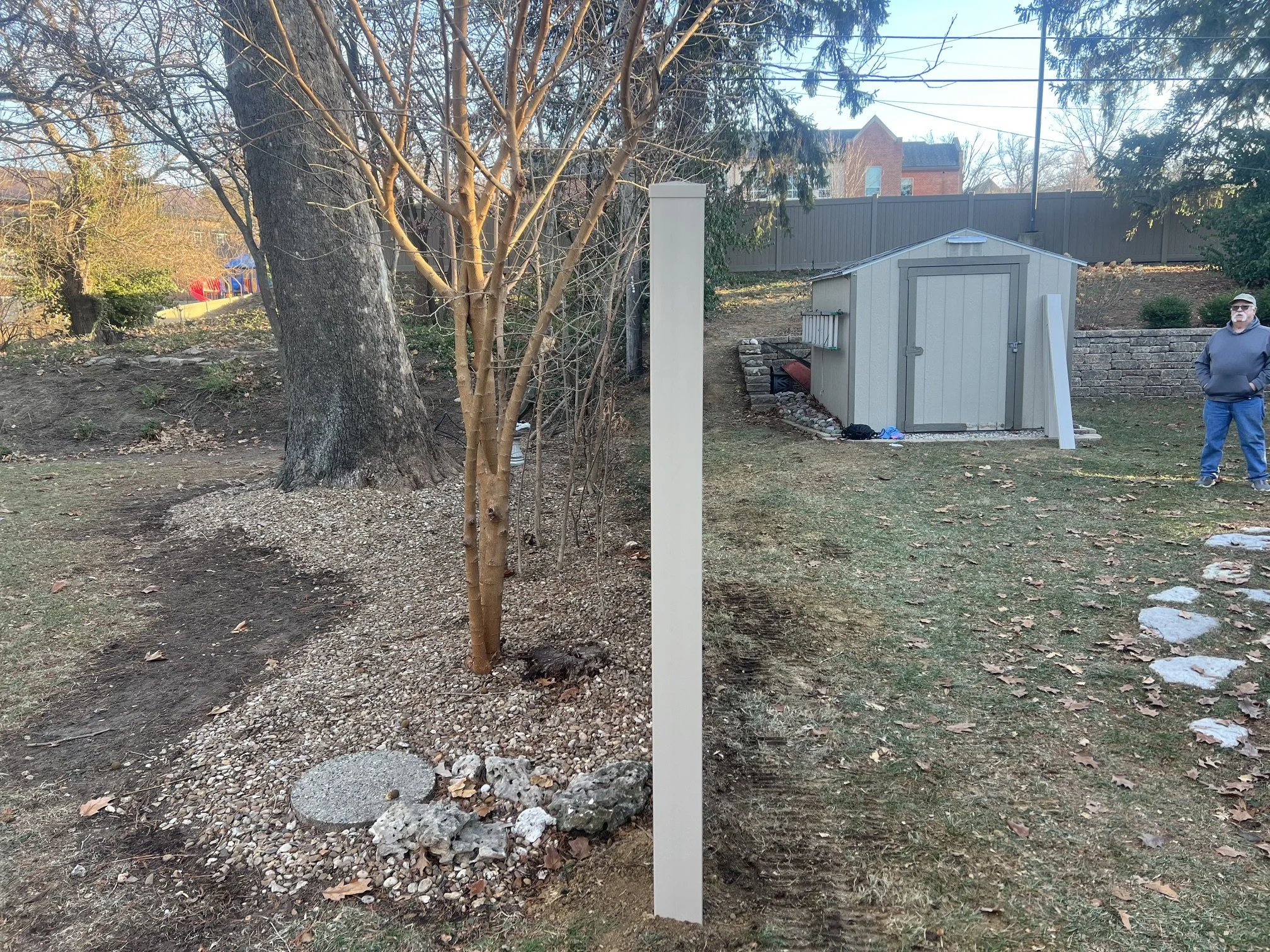 Straight line shot of a tan vinyl fence installed in a residential neighborhood in St. Charles, Missouri