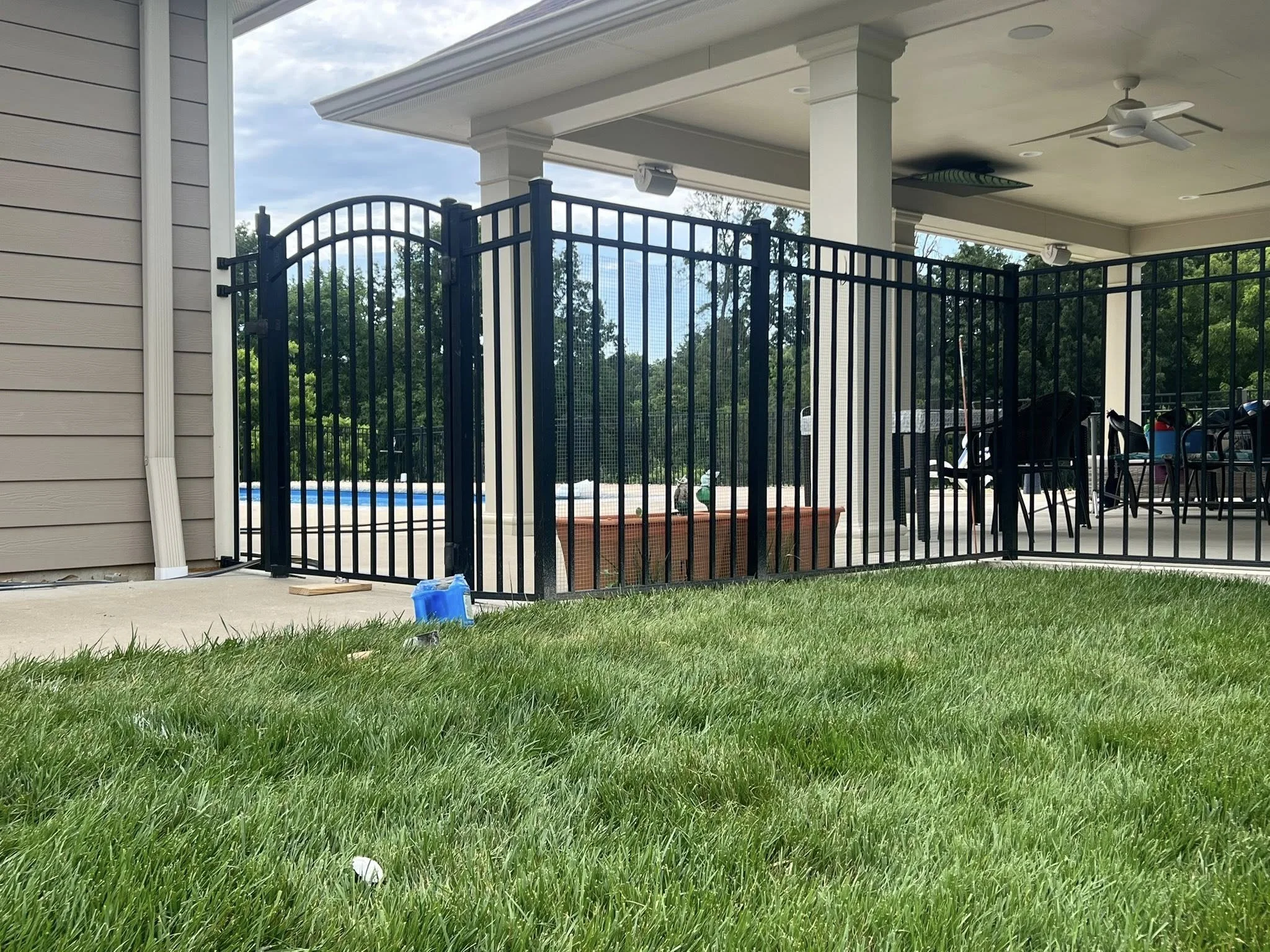 black aluminum fence around pool