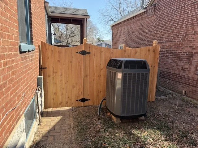 New cedar privacy fence with matching gate professionally installed beside a home in St. Charles Missouri