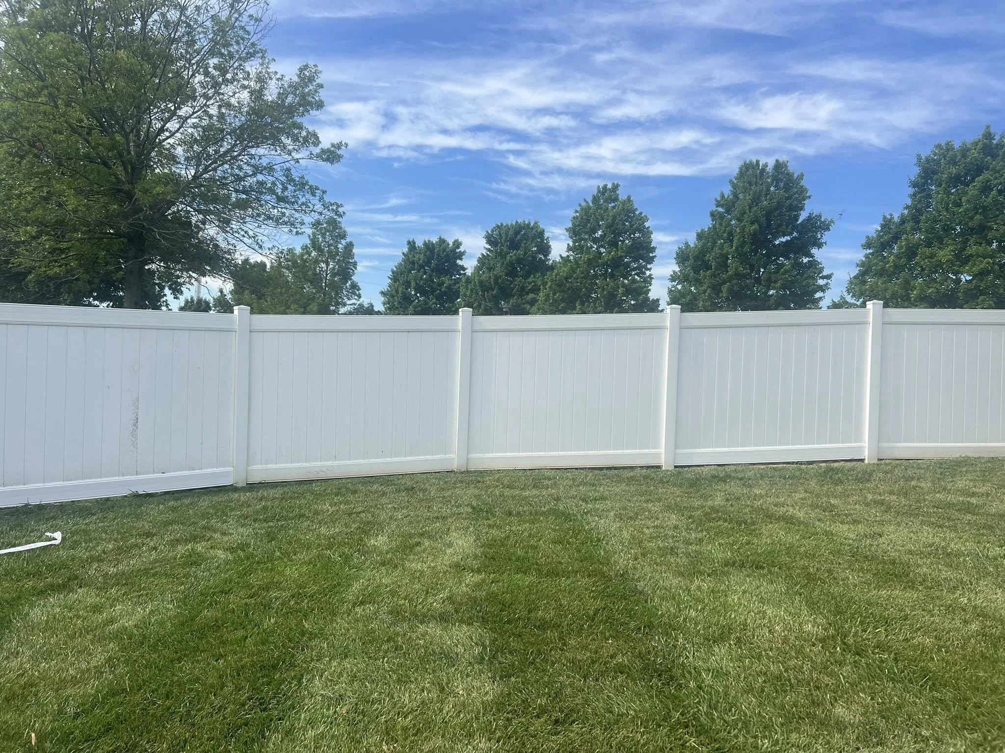 white vinyl privacy fence repair in backyard