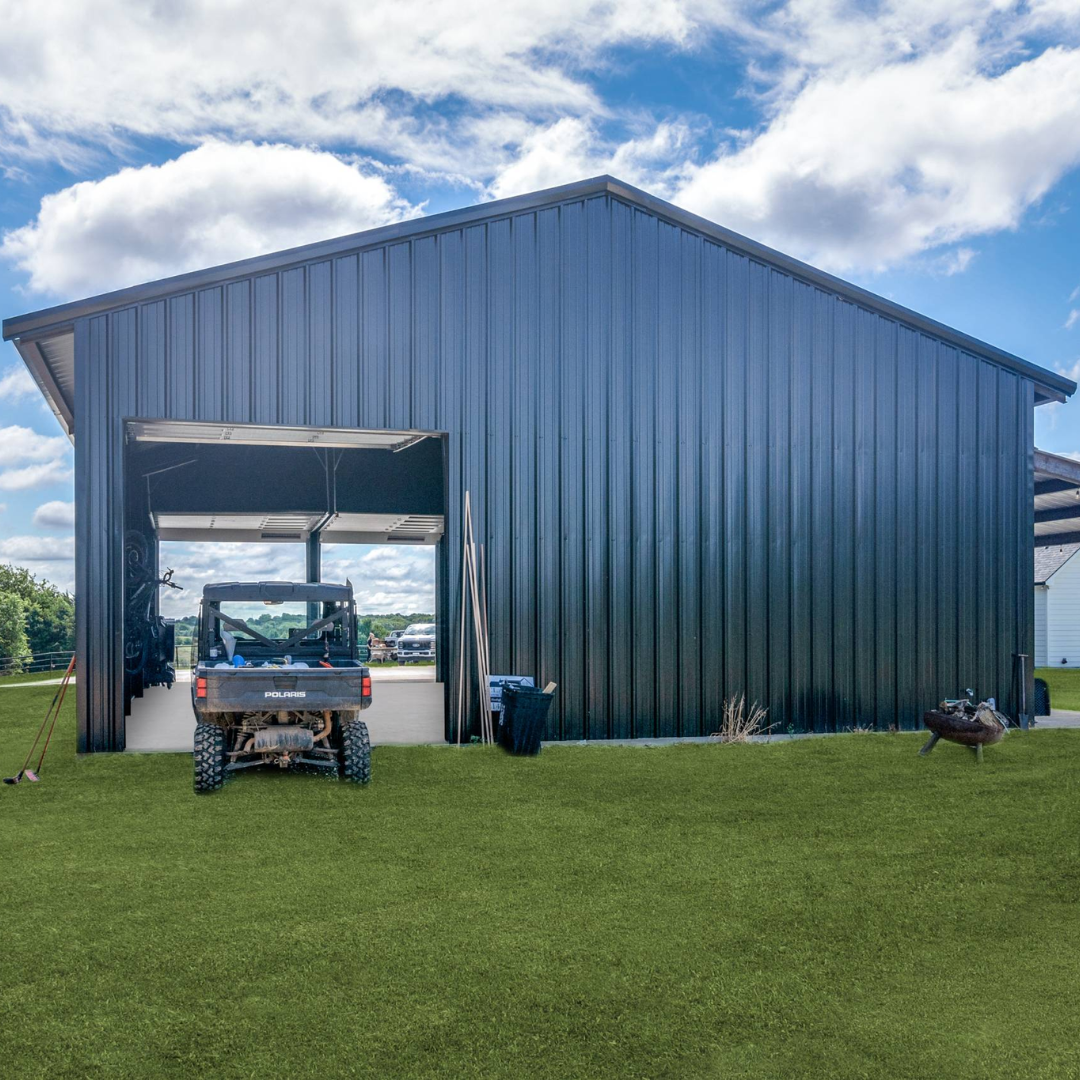 A large black metal shed with an open door, containing a Polaris utility vehicle inside. The shed is situated on a well-maintained grassy yard under a partly cloudy sky.