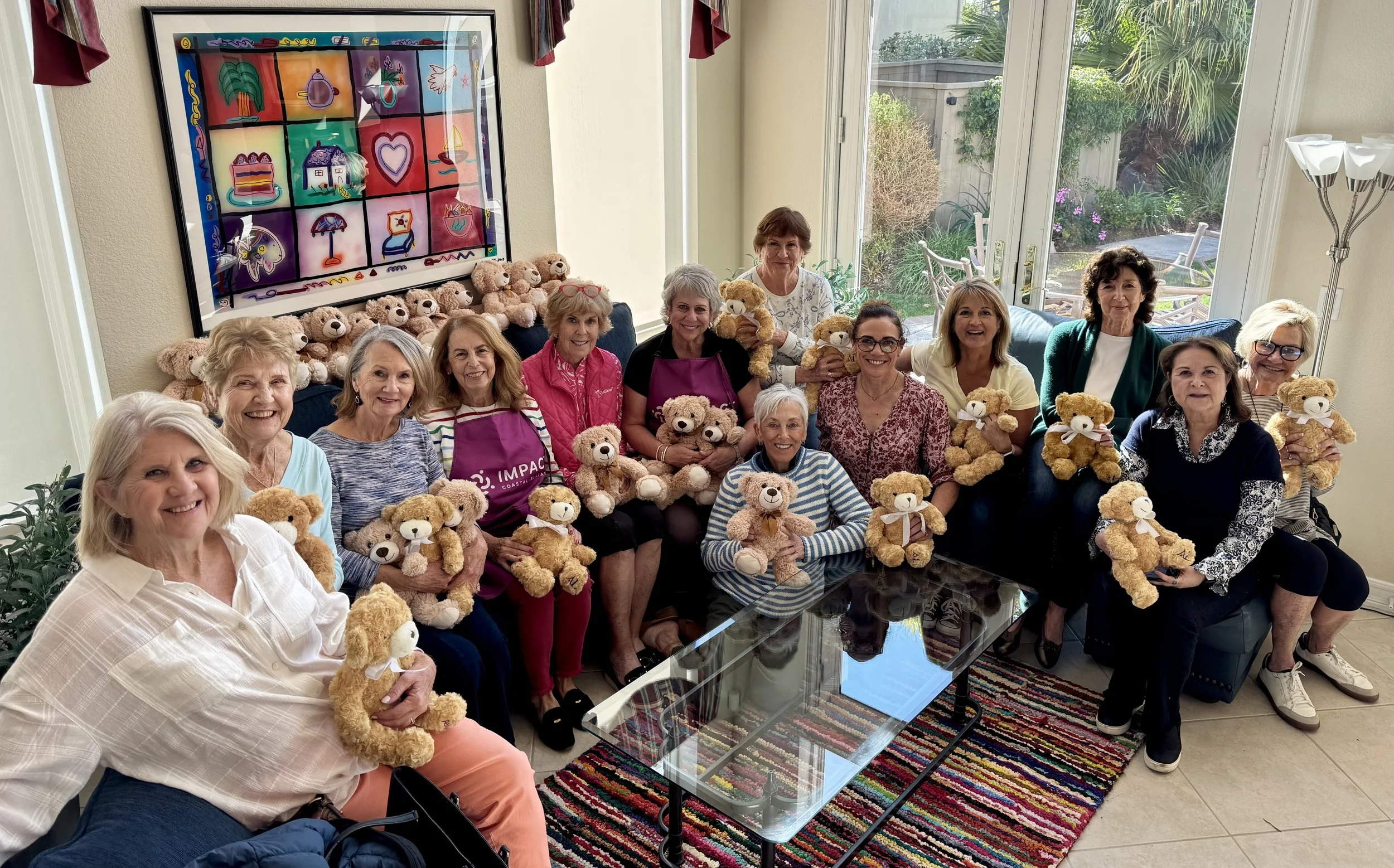 volunteers holding weighted teddy bears