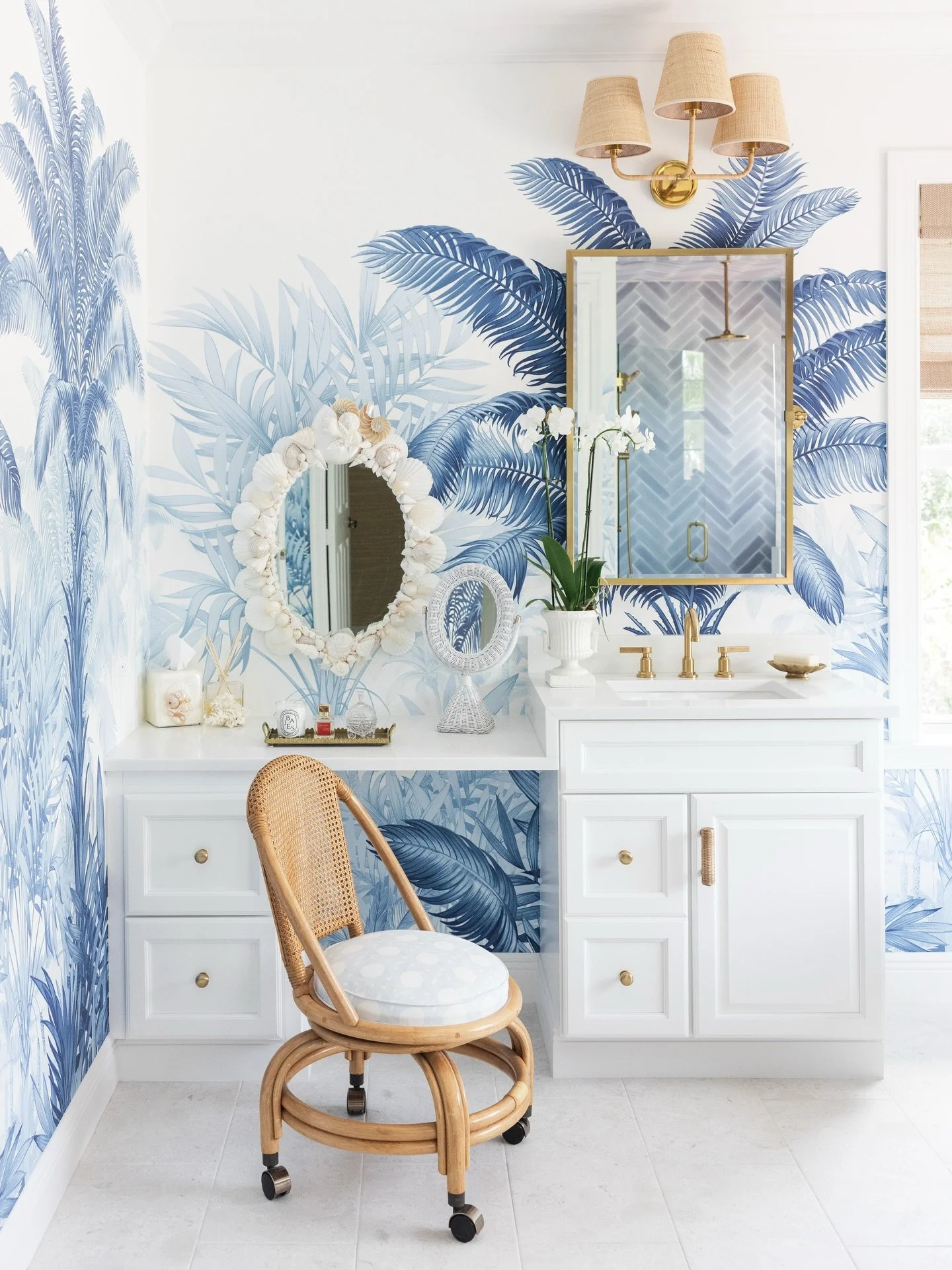 A 2000&rsquo;s builder-grade bathroom, fully reimagined. 

Blue palm mural. Unlacquered brass. Rattan, shell work, and natural texture layered in until the room sung. 

This is the work we live for at Palm and Rhode&hellip; taking what was ordinary a