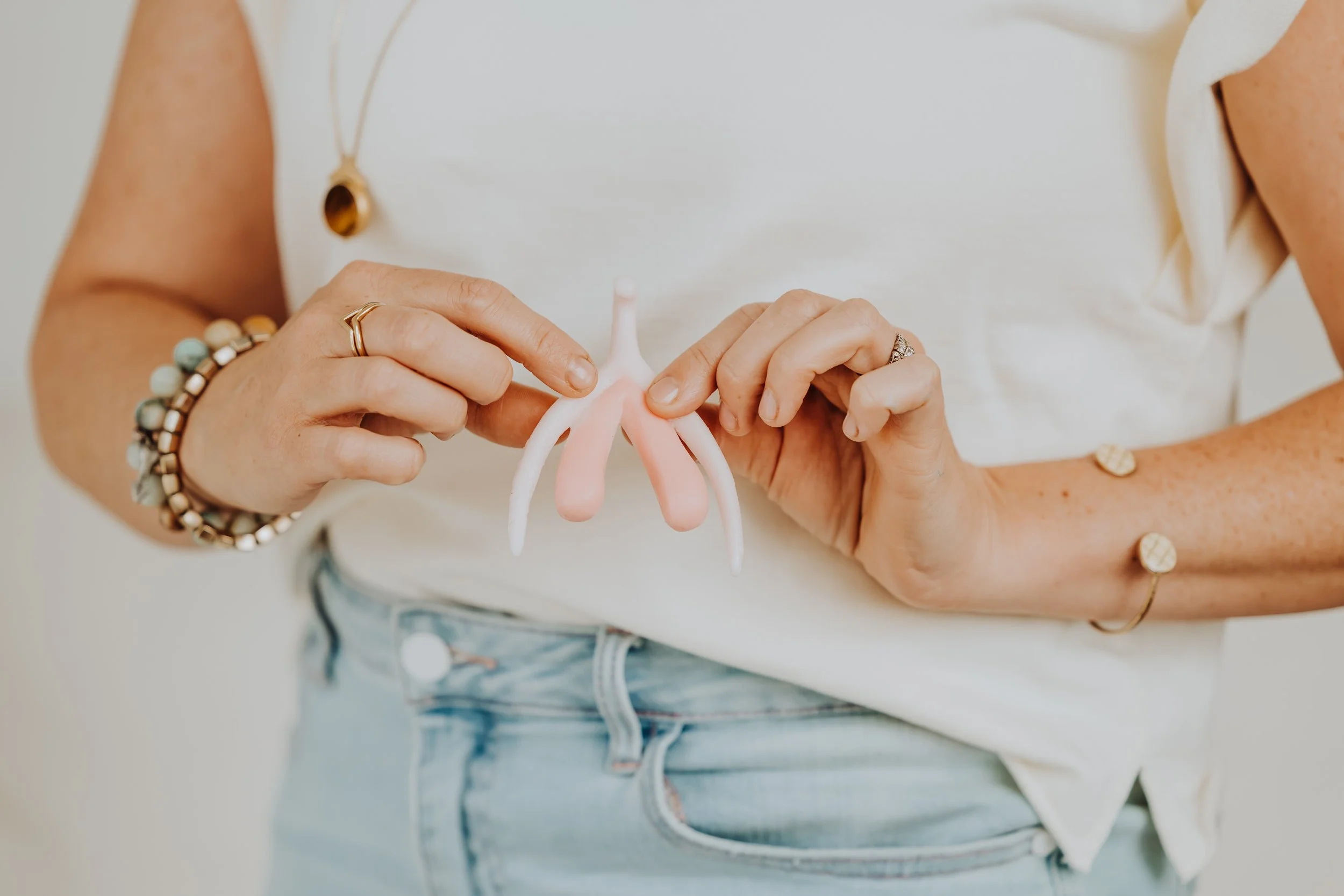 Closeup of Janelle holding a 3d model of the clitoris in front of her